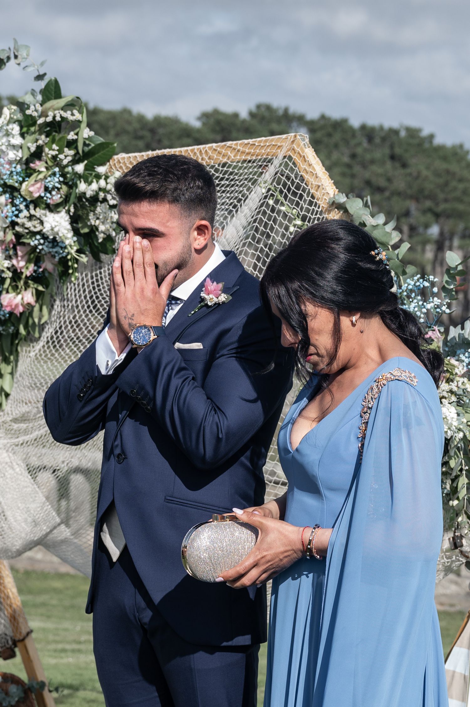 A series of emotional wedding moments showing the groom wiping away tears while standing next to someone in a blue dress.