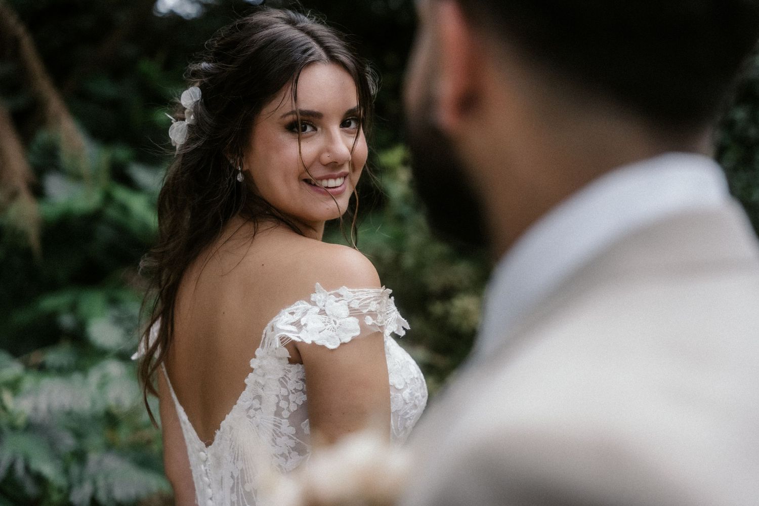 Romantic wedding couple shares intimate moments in a lush garden setting during their outdoor photo session.