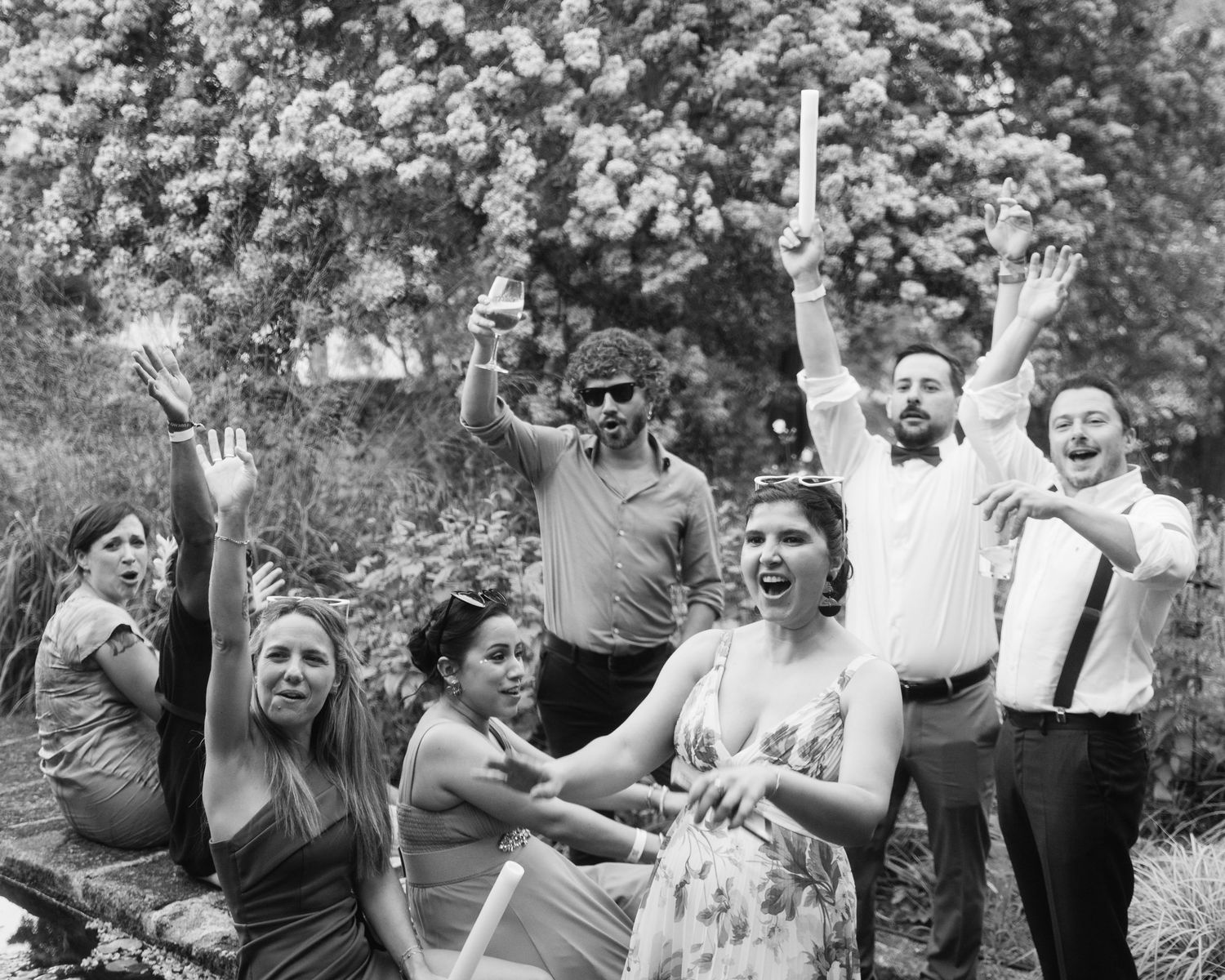 A black and white photo series showing people celebrating and having fun at an outdoor gathering.