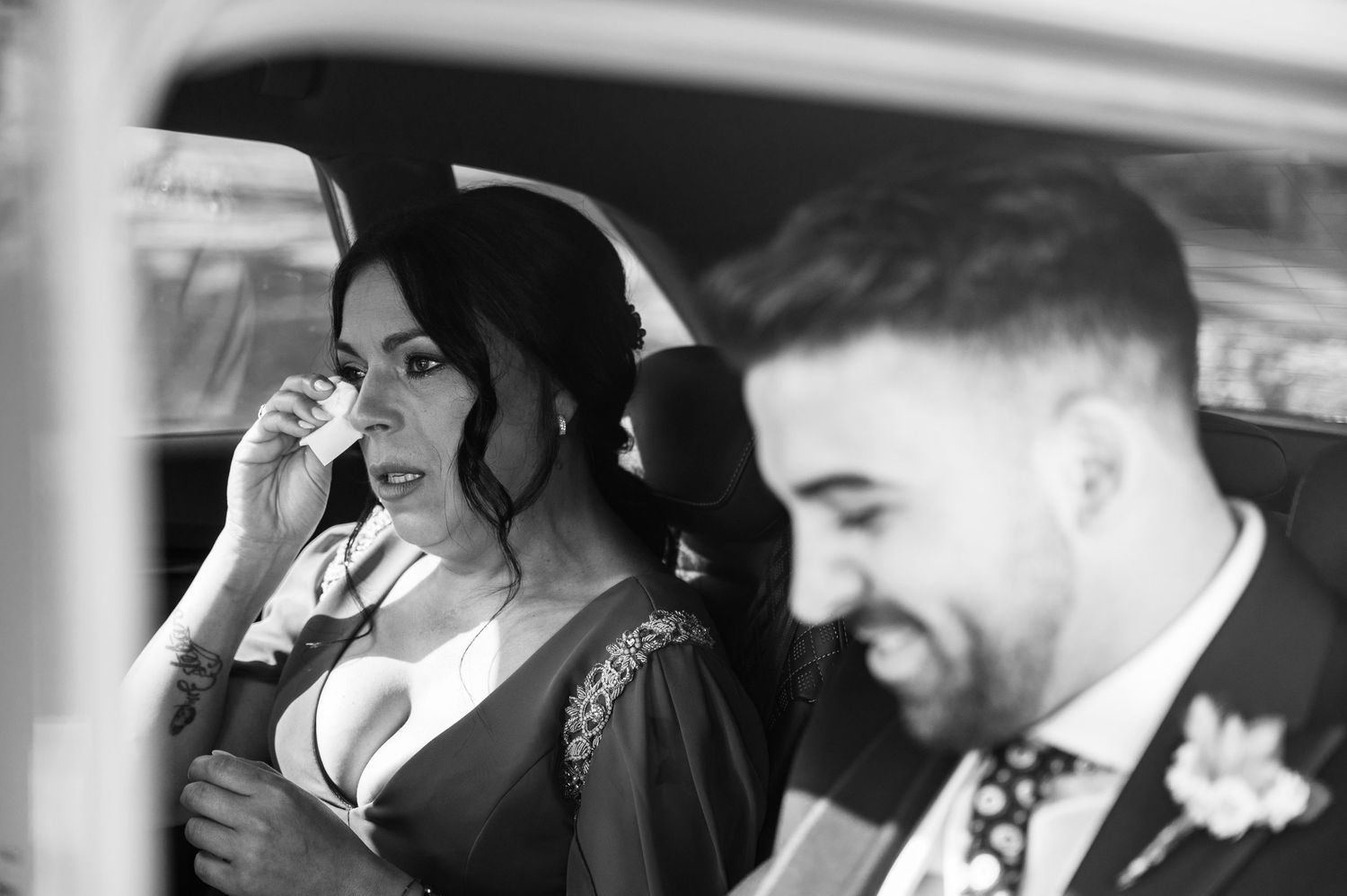 Black and white photo of a couple sharing an intimate moment during their wedding celebration.