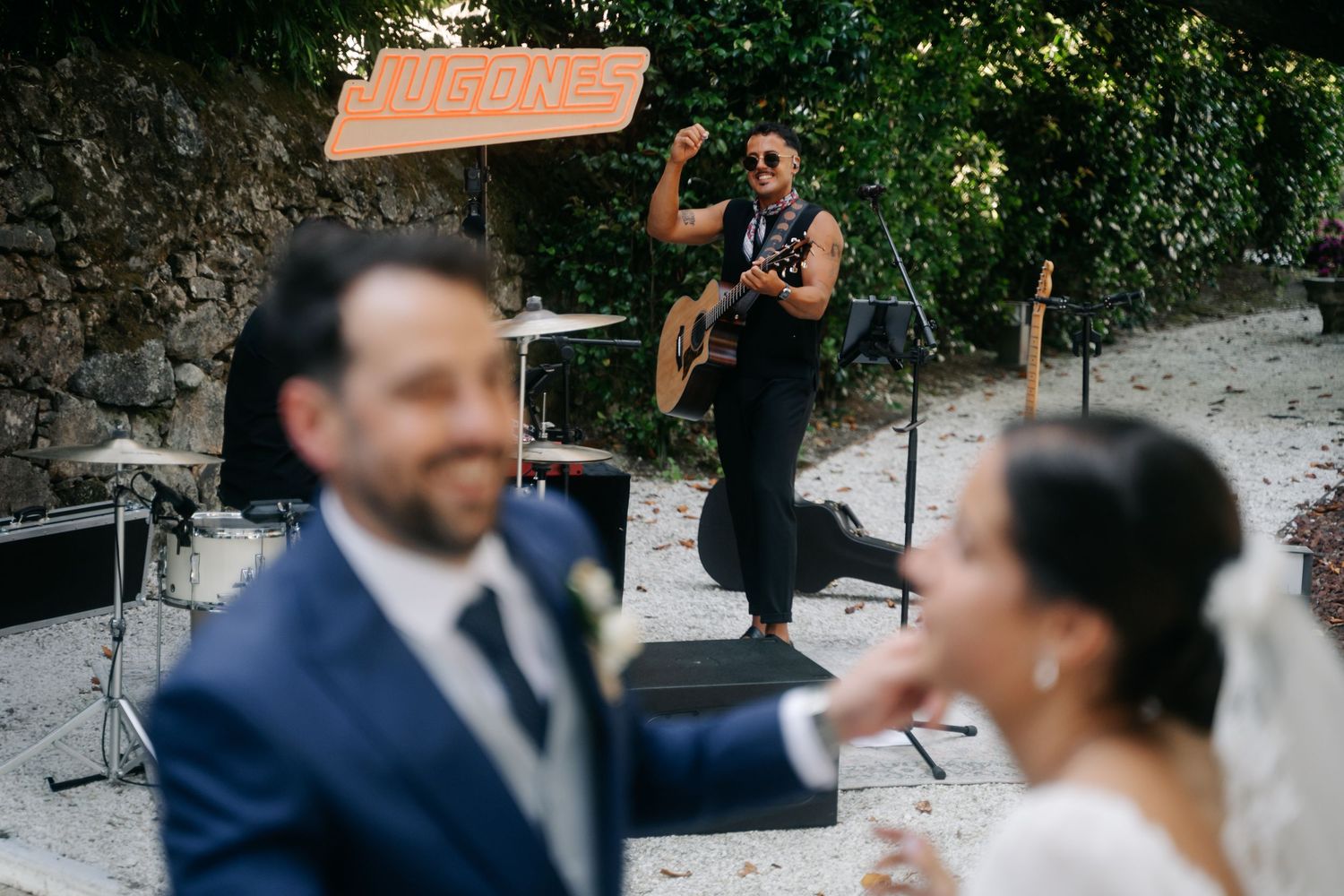 Wedding party celebrating and dancing outdoors during a joyful reception.