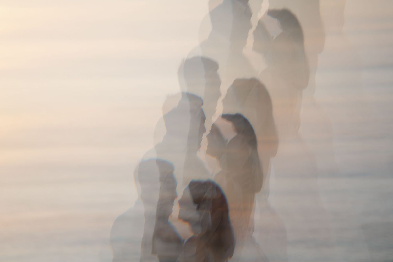 Multiple overlapping silhouettes create a dreamy, ethereal effect in soft lighting.