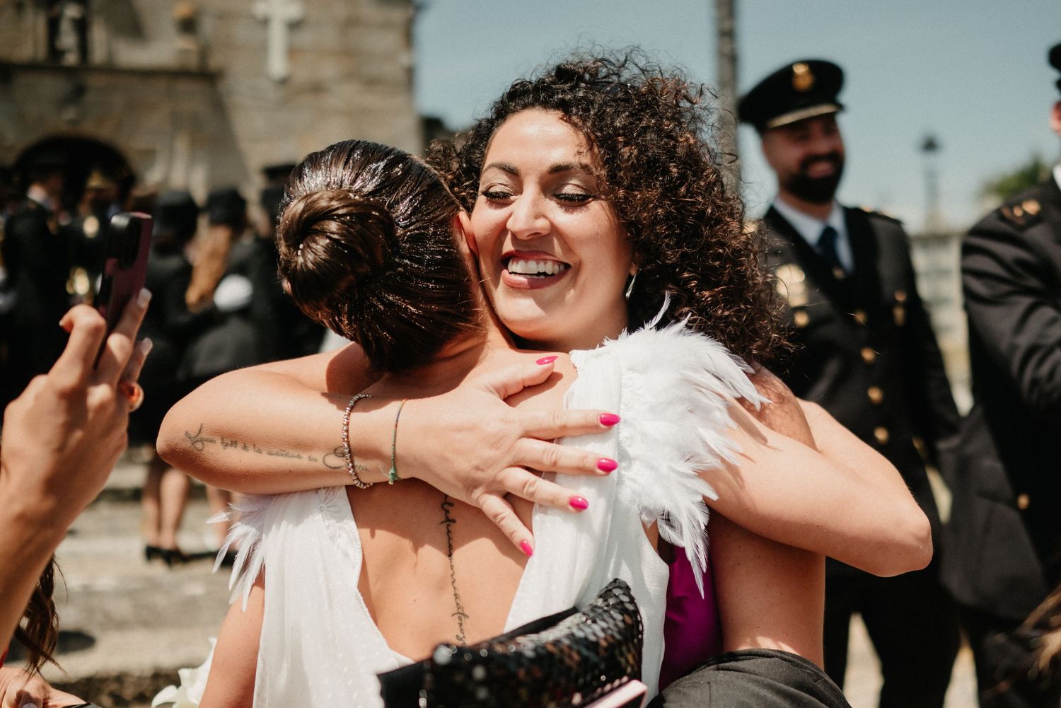 Joyful celebration with guests hugging and dancing in an outdoor setting.