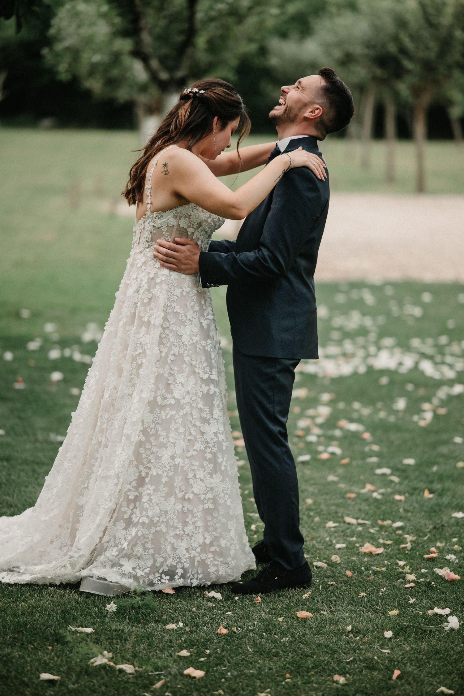 A sequence of wedding photos capturing a couple's joyful dance moves on a grassy lawn with scattered autumn leaves.