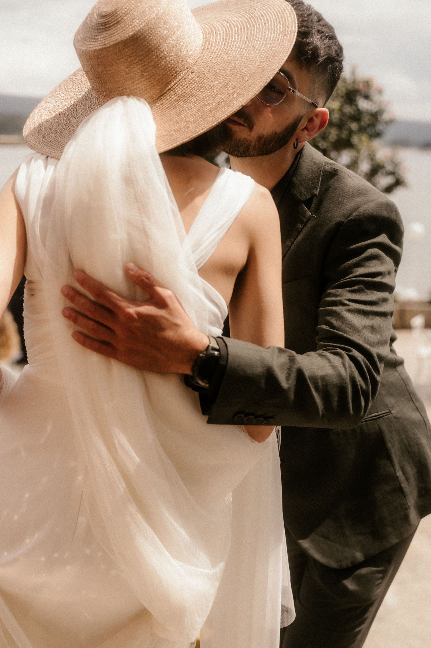 A romantic sequence of wedding photos showing tender embraces between a couple in formal attire.