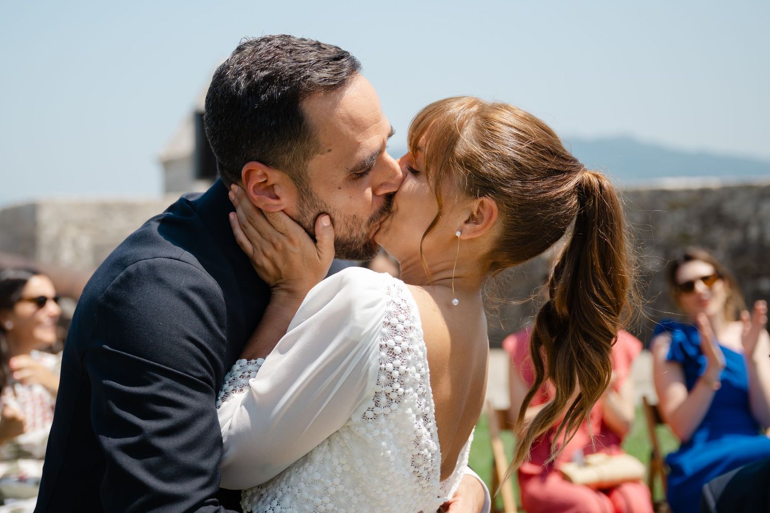 A romantic collage of wedding moments showing couples kissing and embracing during an outdoor celebration.