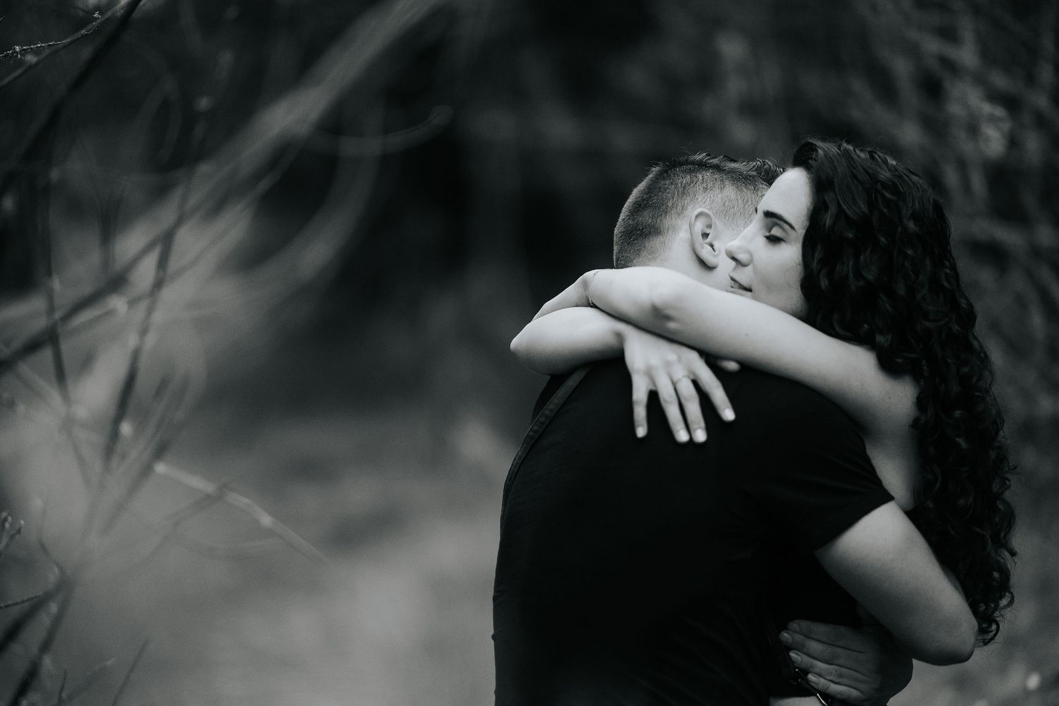 A romantic black and white photo series showing intimate moments between a couple embracing and kissing.
