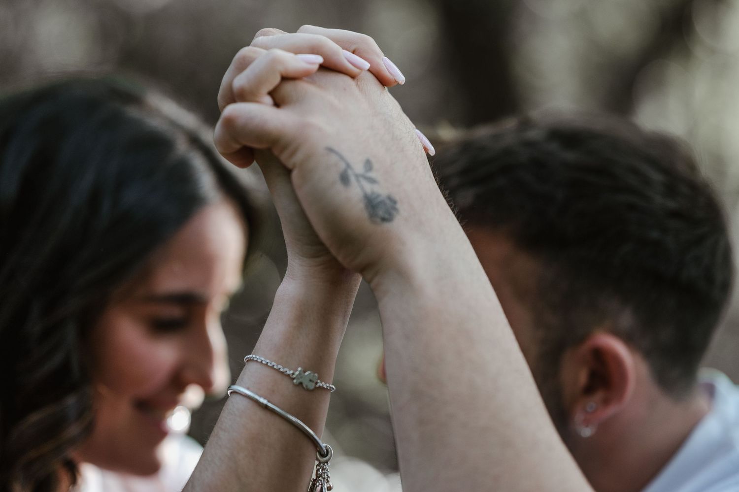 Close-up shot of a couple's intimate moment as they embrace and kiss with soft focus and natural lighting.