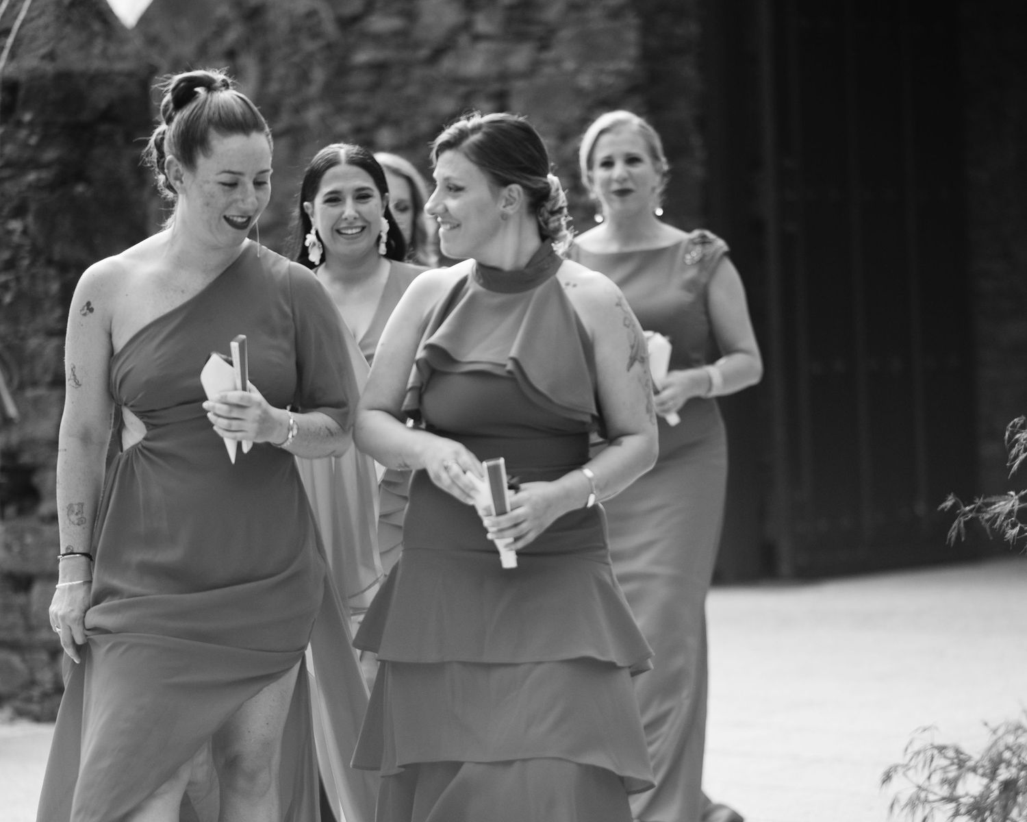 Wedding guests enjoying champagne and conversation during an outdoor celebration.
