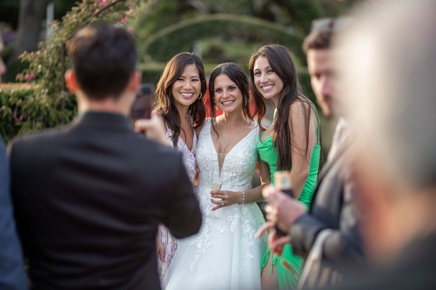 A group of people laughing and smiling together outdoors in a candid moment during a social gathering.