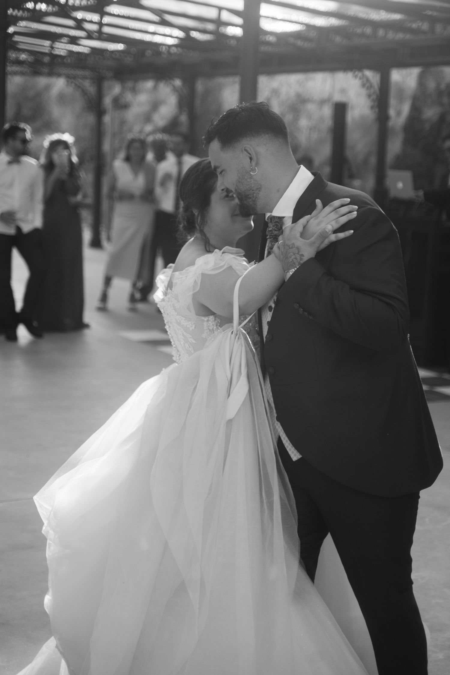 A black and white wedding dance sequence showing a couple in formal attire.