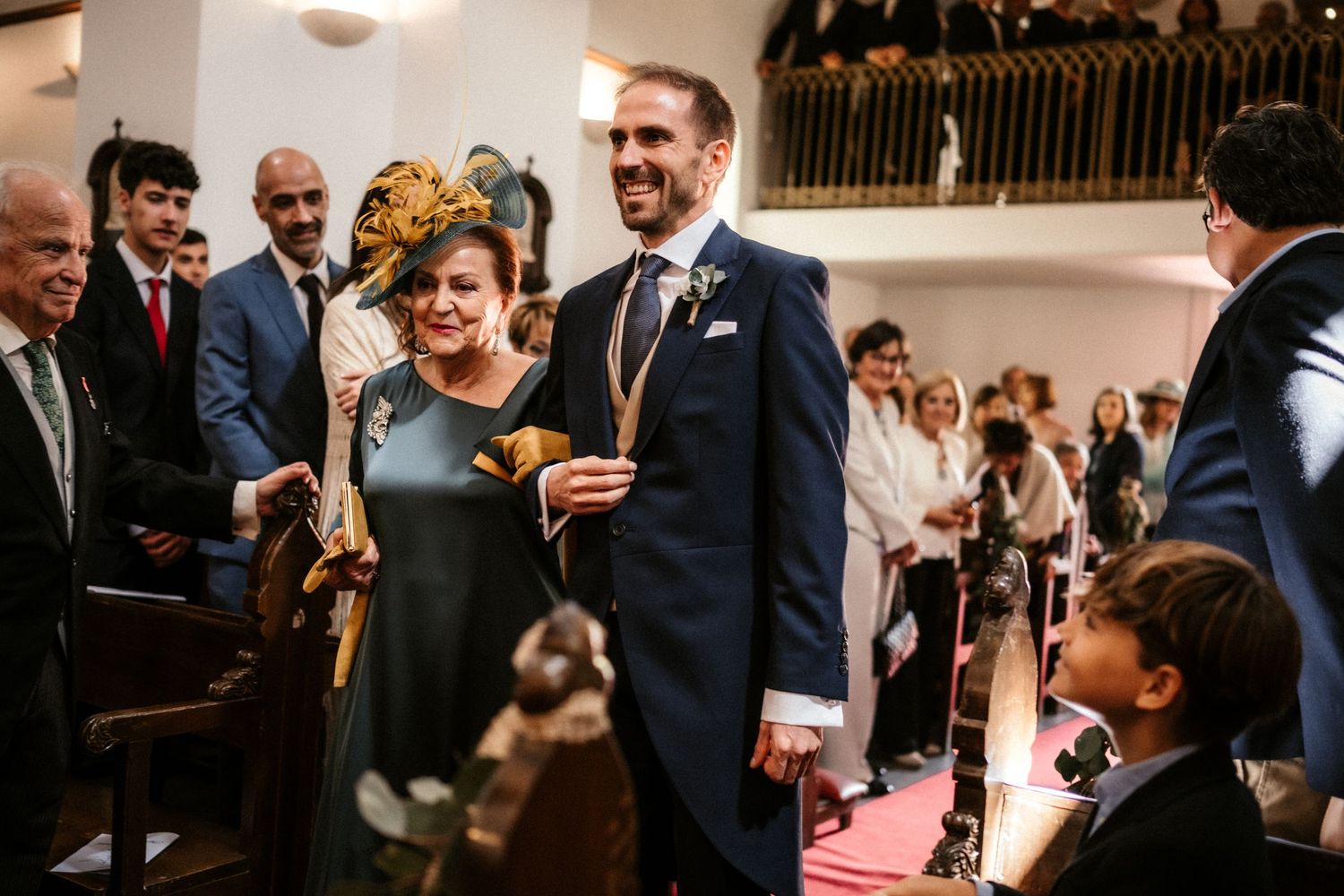 Wedding guests celebrate and laugh together during an indoor reception ceremony.