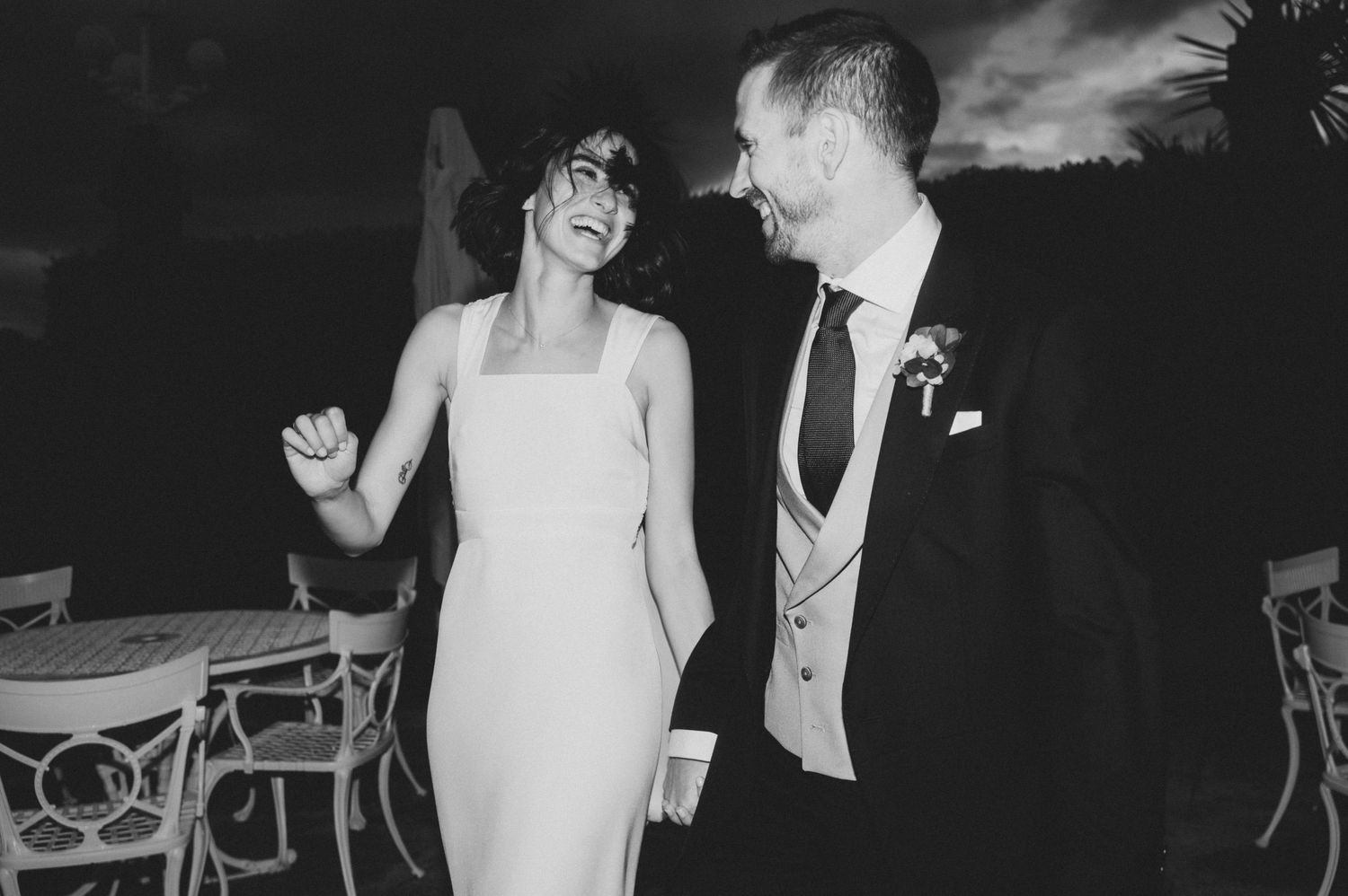 Vintage-style black and white wedding photo of a couple sharing a romantic dance moment.