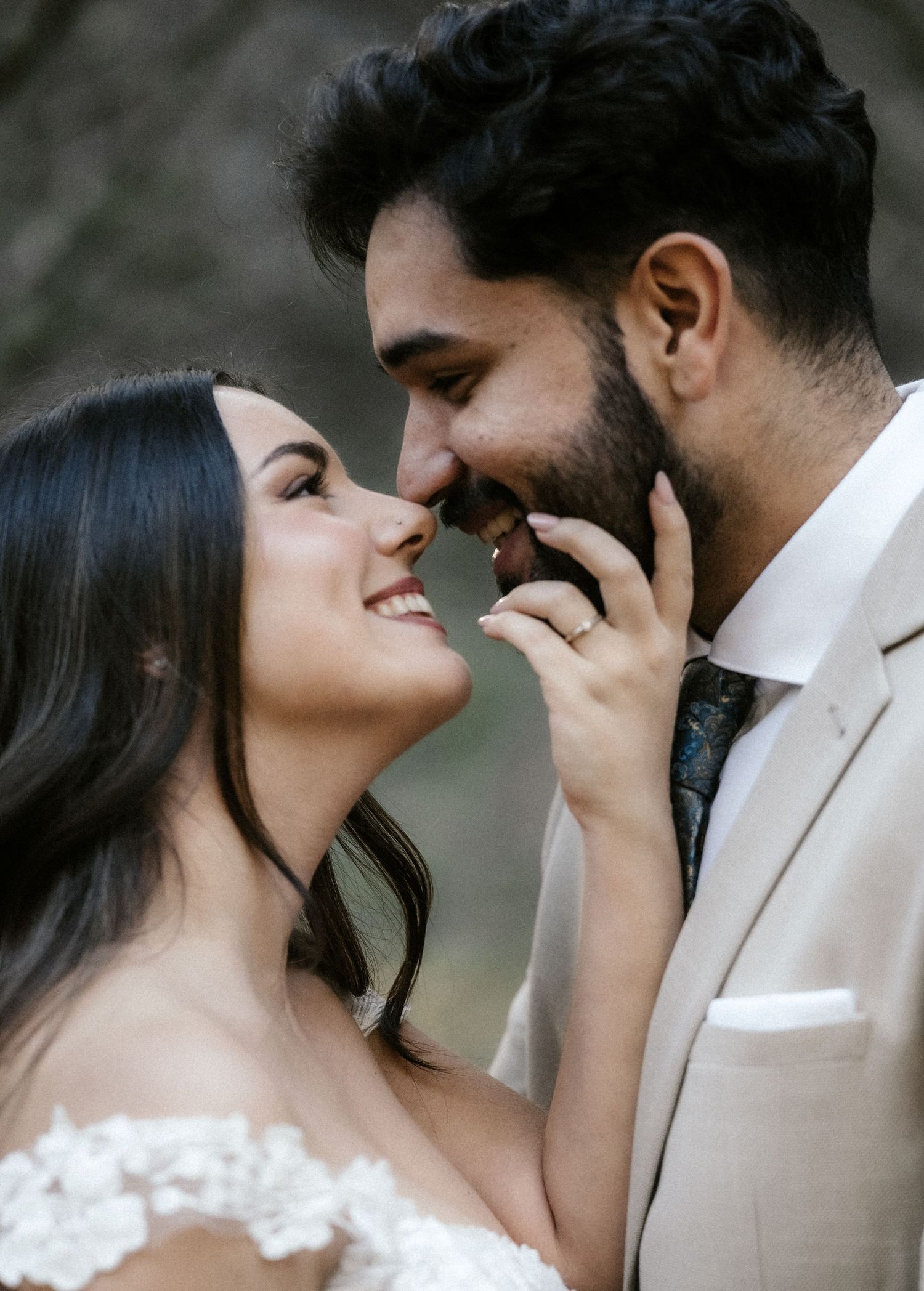 A romantic moment between newlyweds in wedding attire as they share an intimate close-up moment together.