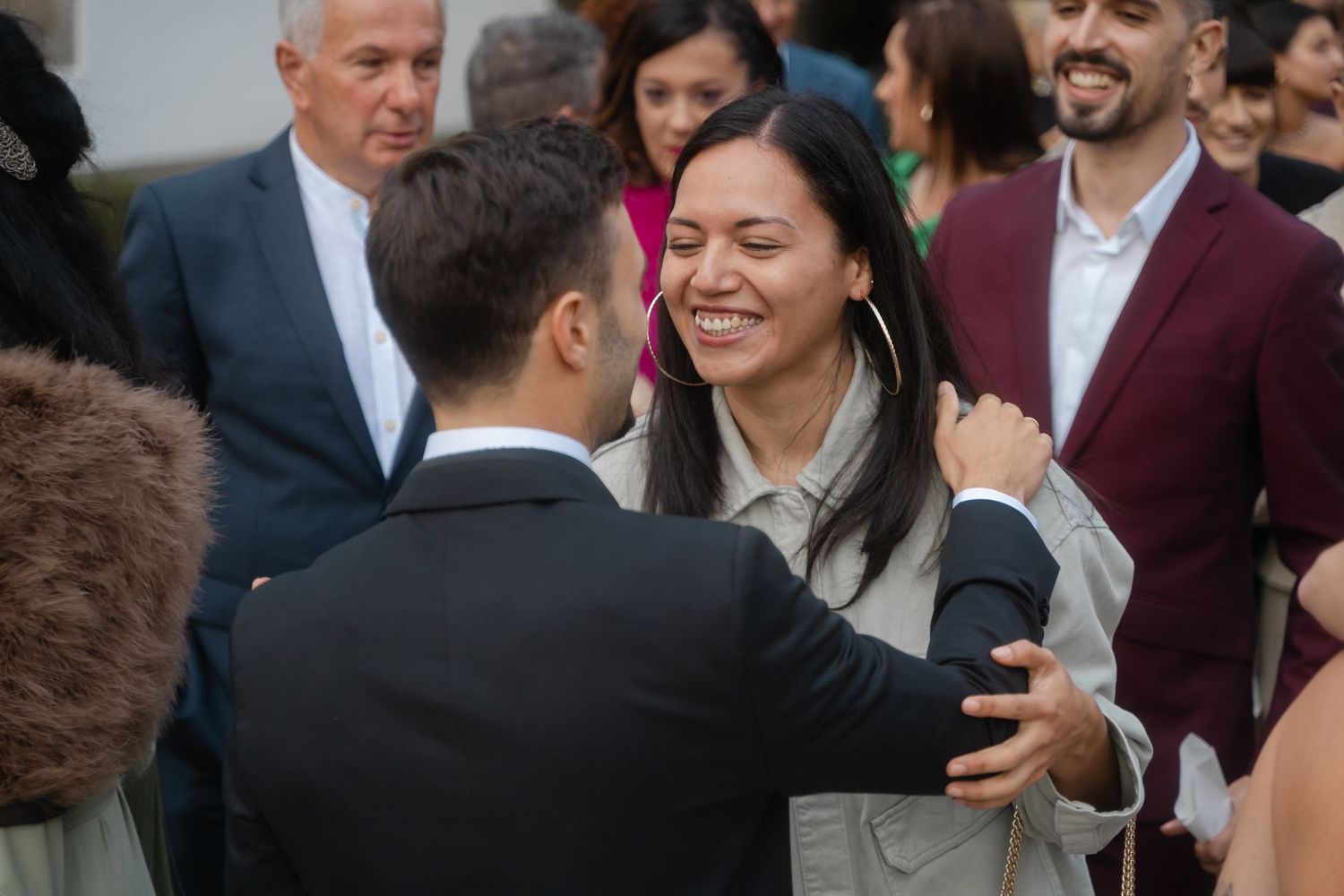 Wedding guests mingle and socialize during an outdoor reception.