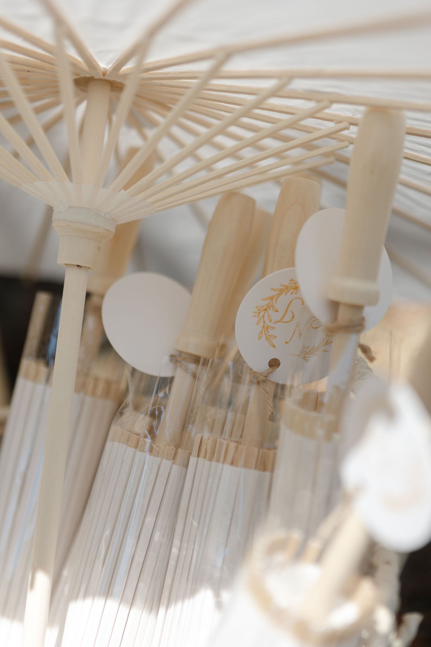 Elegant white hanging decorative light fixtures with intricate geometric patterns create a modern wedding reception atmosphere.