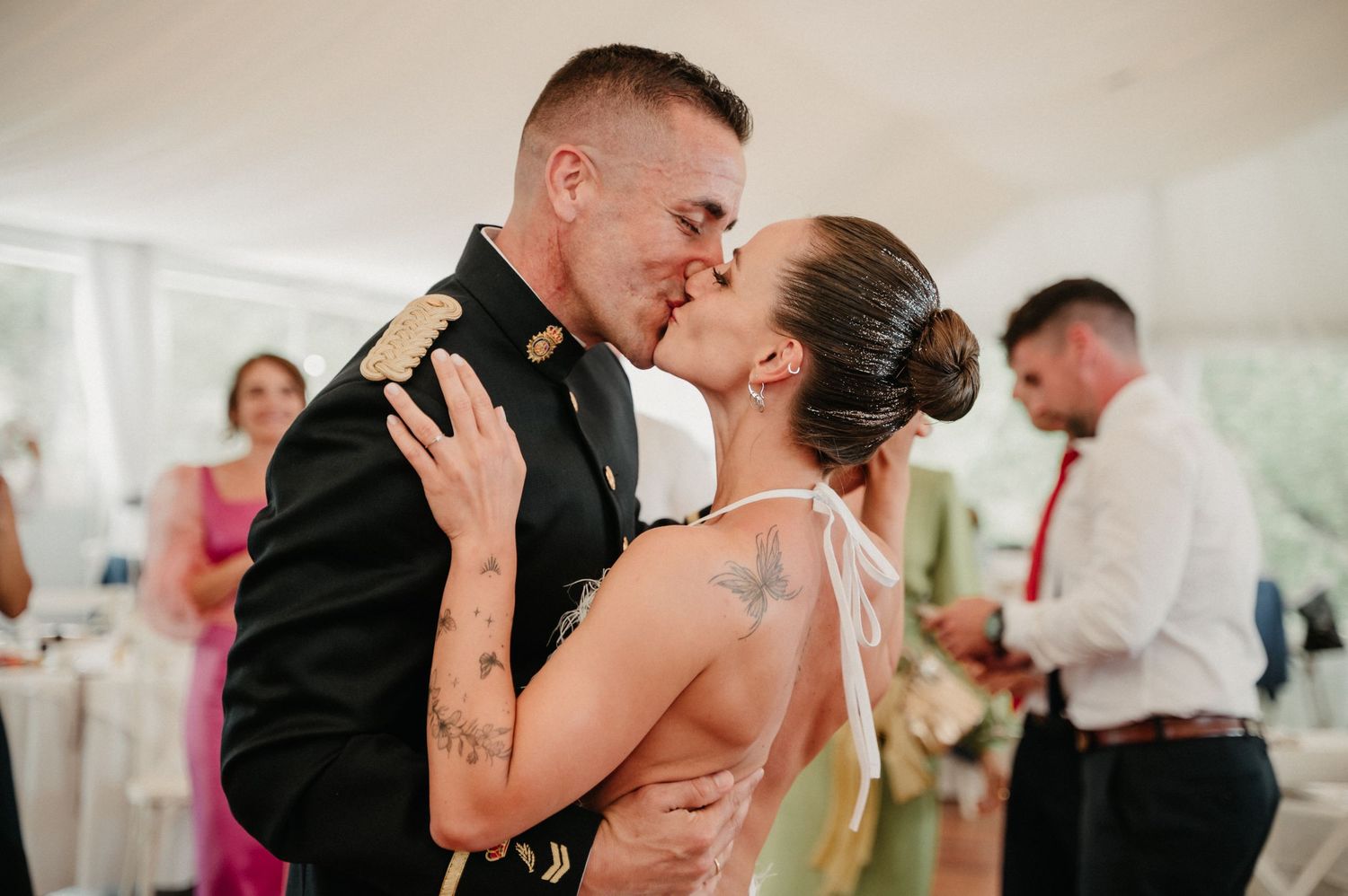 A sequence of romantic moments between a couple during their wedding celebration in a light-filled room.