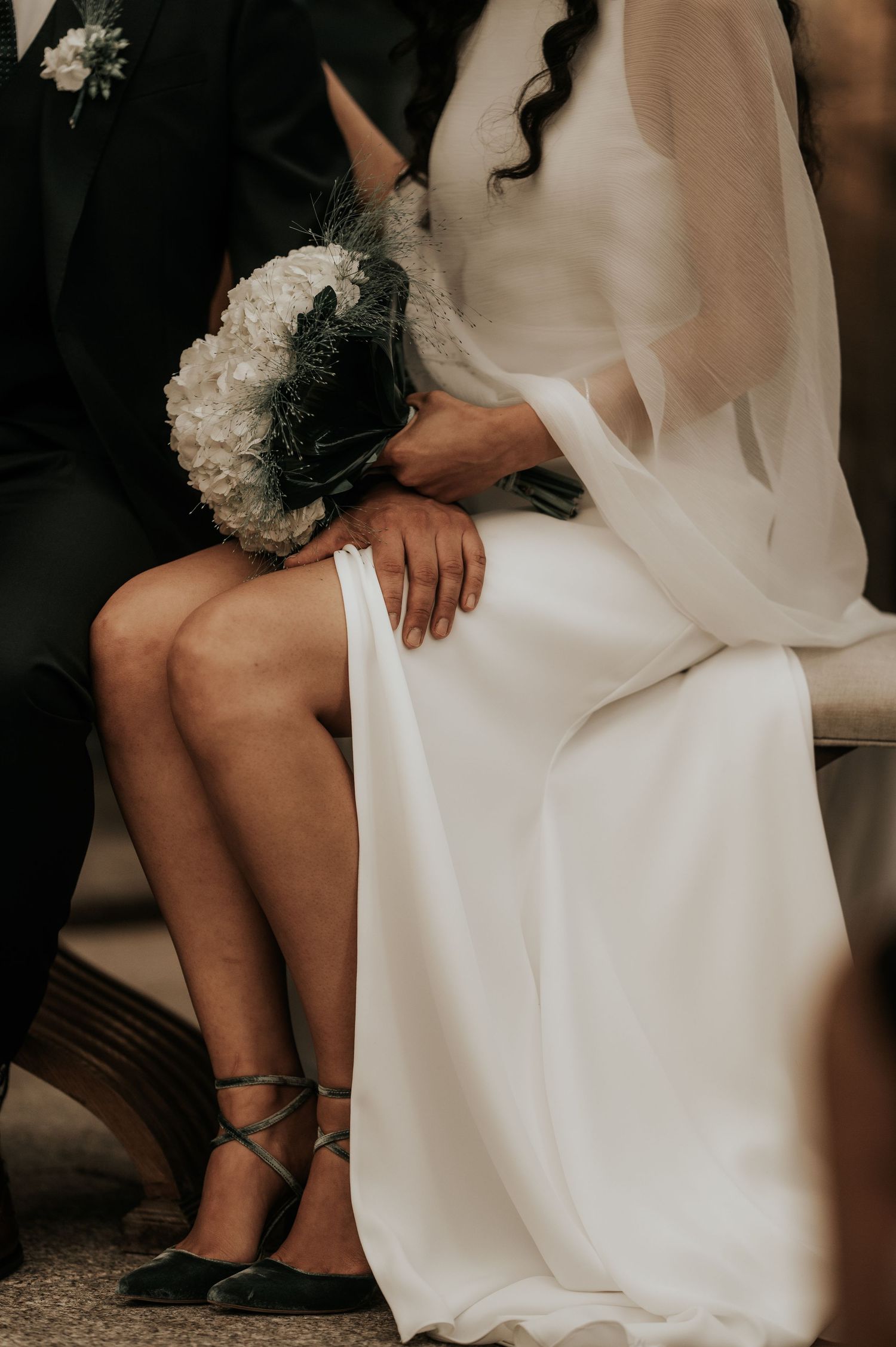 Series of artistic wedding photos showing close-up details of a white bridal gown and bouquet.