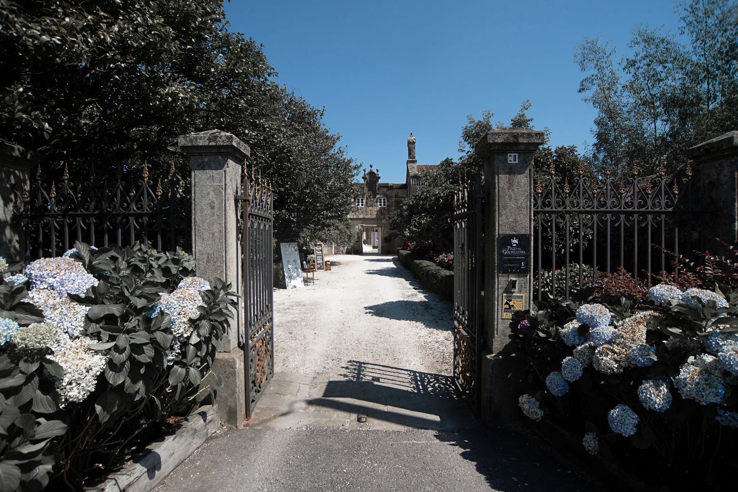 Panoramic sequence showing a narrow stone pathway winding through a traditional Mediterranean village in daylight.