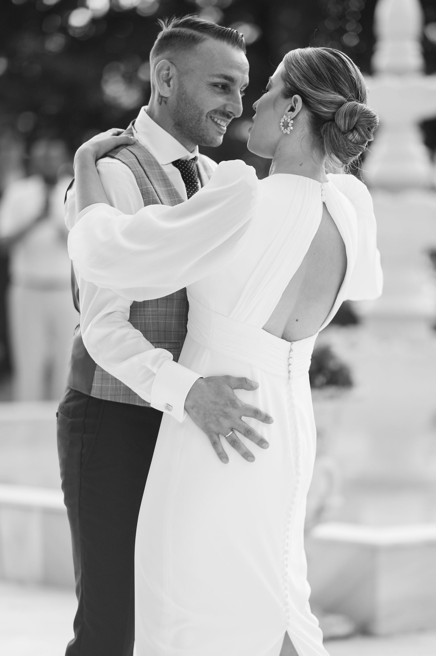 Black and white photo of a couple sharing an intimate dance moment at their wedding celebration.