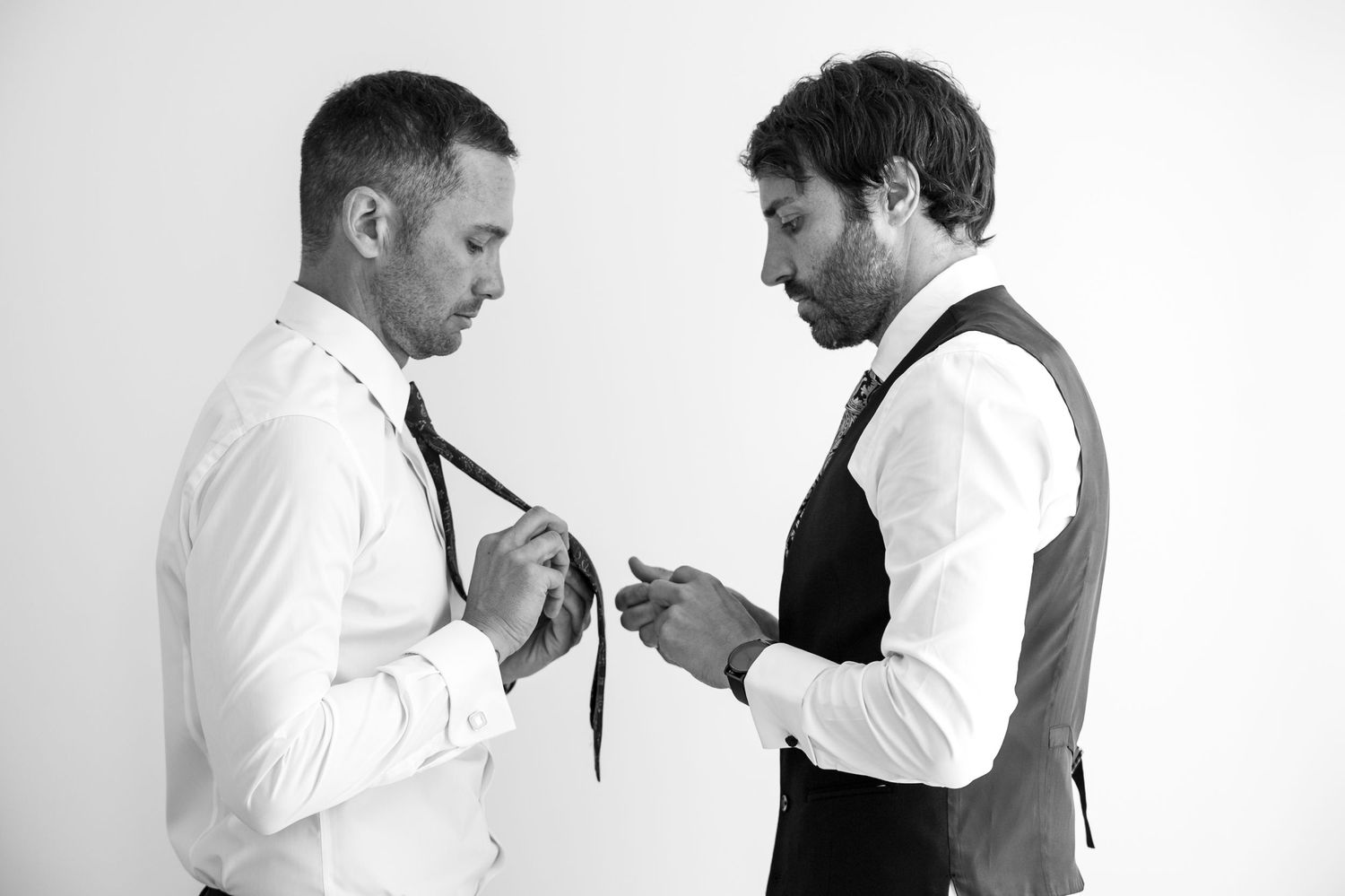 Two people in white shirts having a confrontational interaction in black and white.