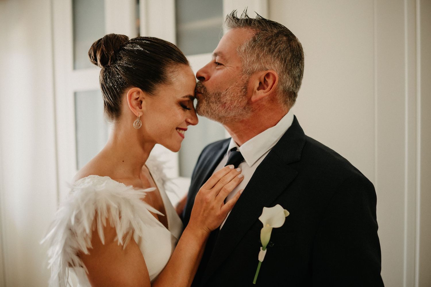 Intimate wedding moment captured in black and white with soft natural lighting.
