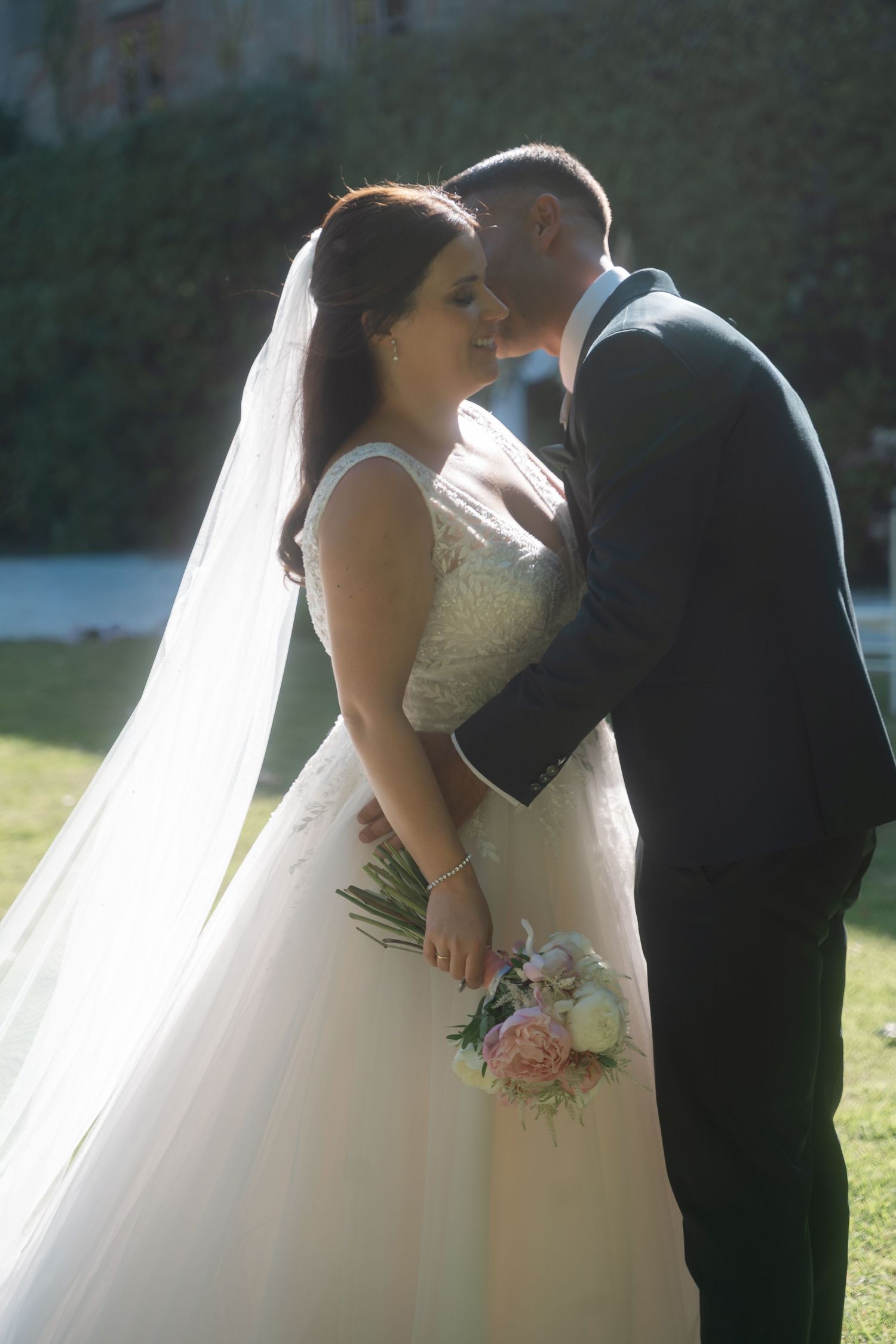 Romantic wedding sequence capturing intimate moments between newlyweds with a flowing white veil in natural light.