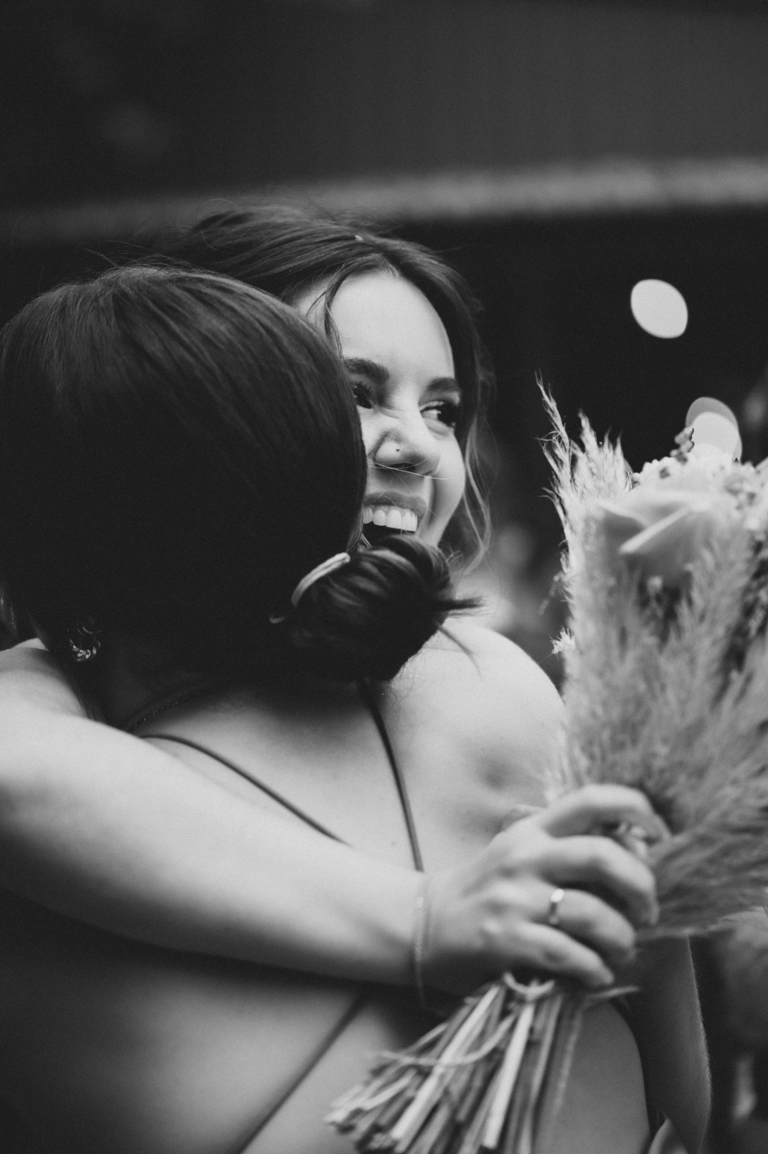 Artistic black and white close-up shots of wedding moments with dried flower bouquets.