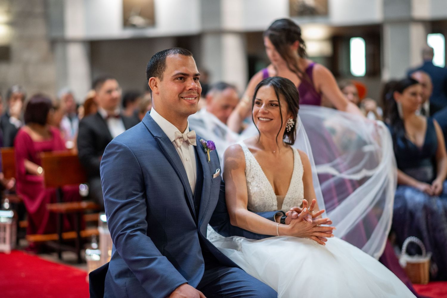 Wedding ceremony guests seated in church pews during traditional celebration.