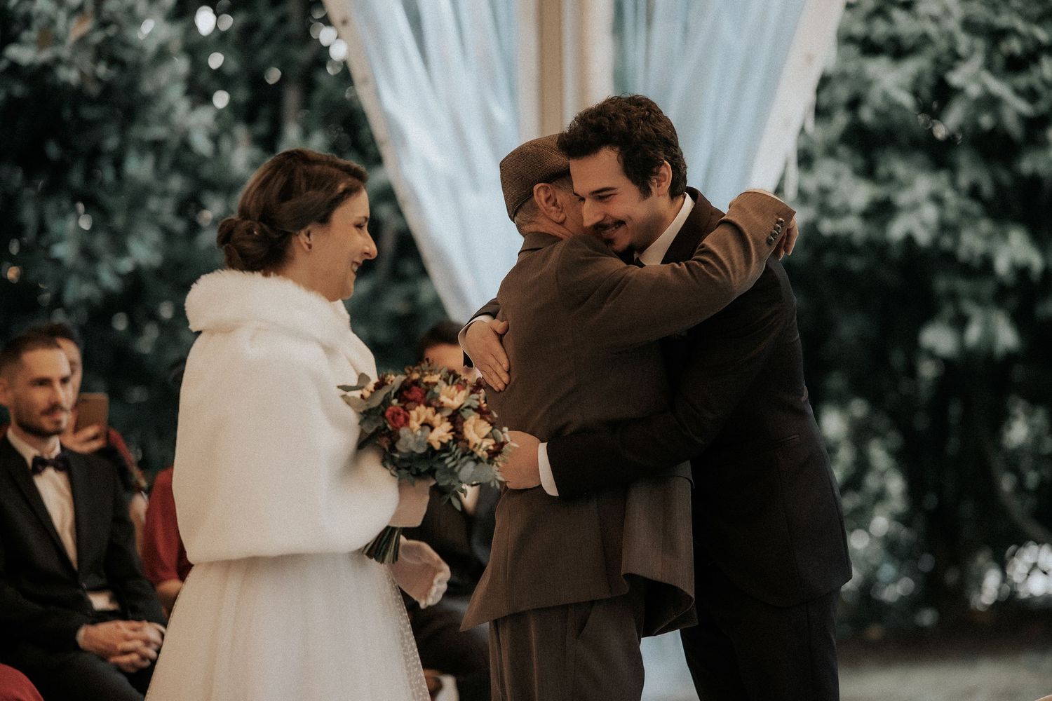 Four candid moments from a wedding ceremony showing couples embracing in formal attire.