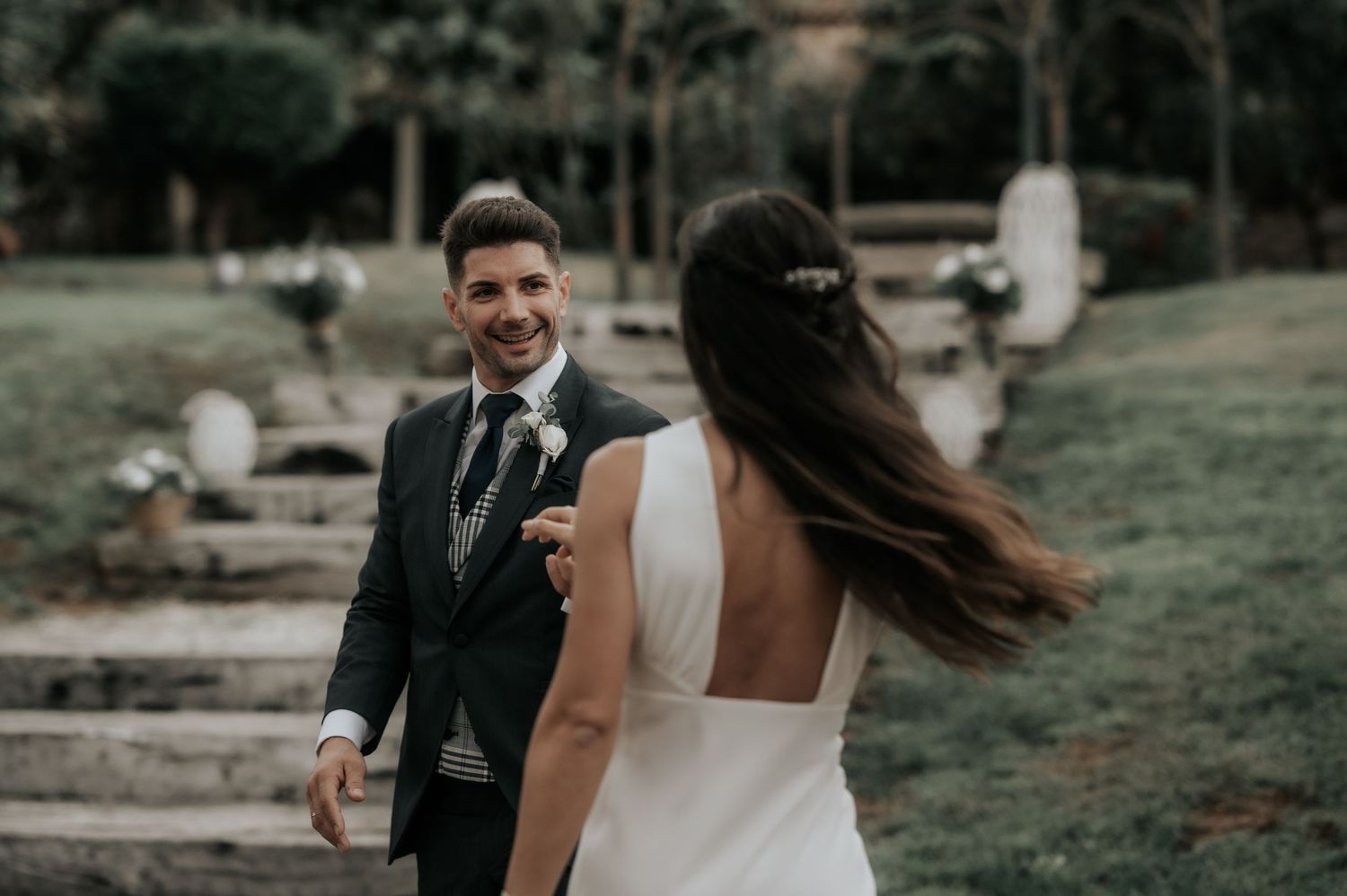 Bride and groom share joyful candid moments during their outdoor wedding photoshoot.
