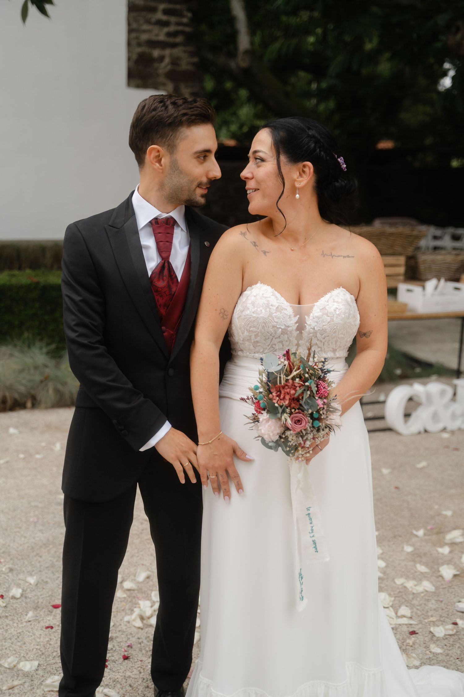 Bride in white dress and groom in dark suit share playful moments during outdoor photo session.