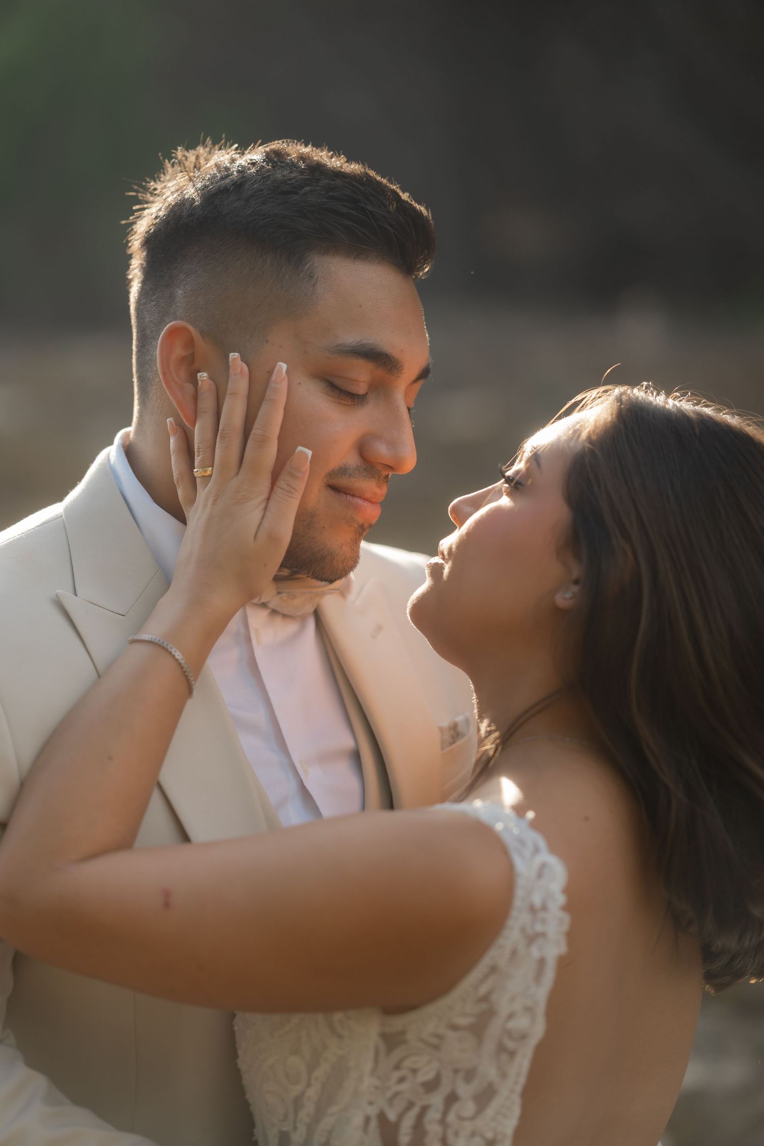 Tender close-up wedding portraits showing affectionate moments between a couple in natural lighting.