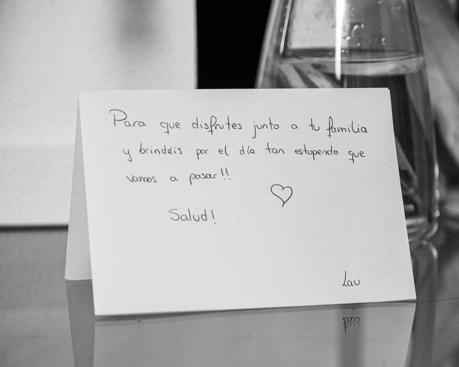A black and white close-up photograph of handwritten notes and cards arranged together.