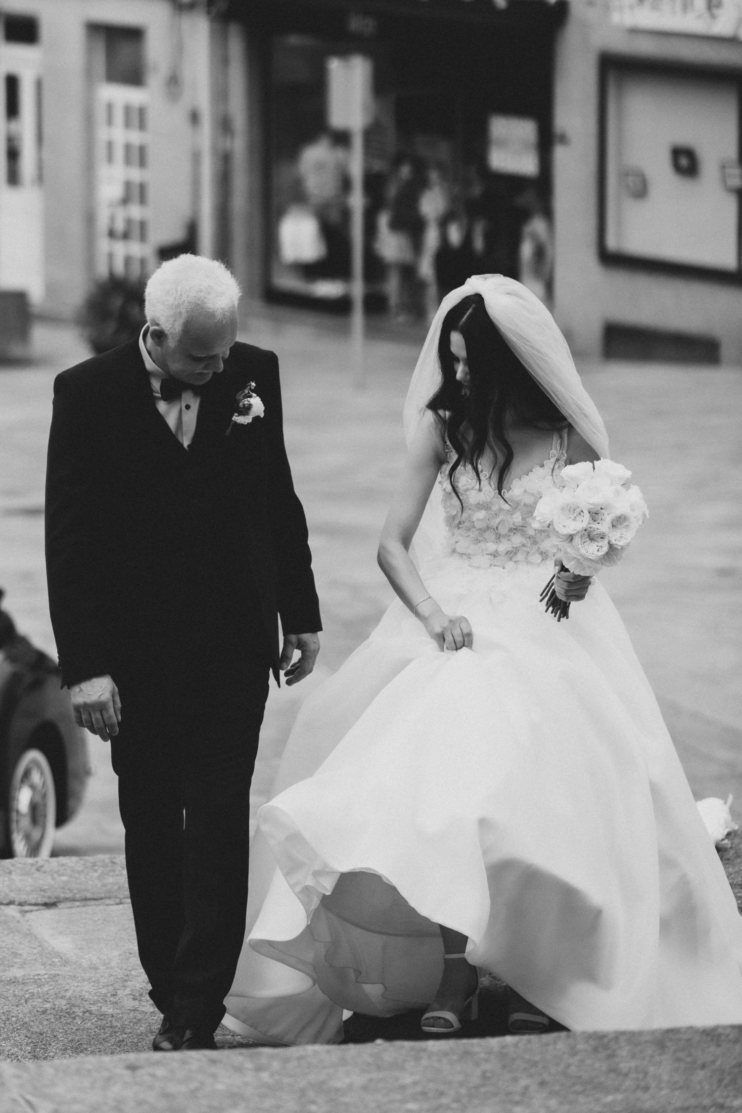 A series of black and white wedding photos showing the bottom of a flowing white dress and formal attire.