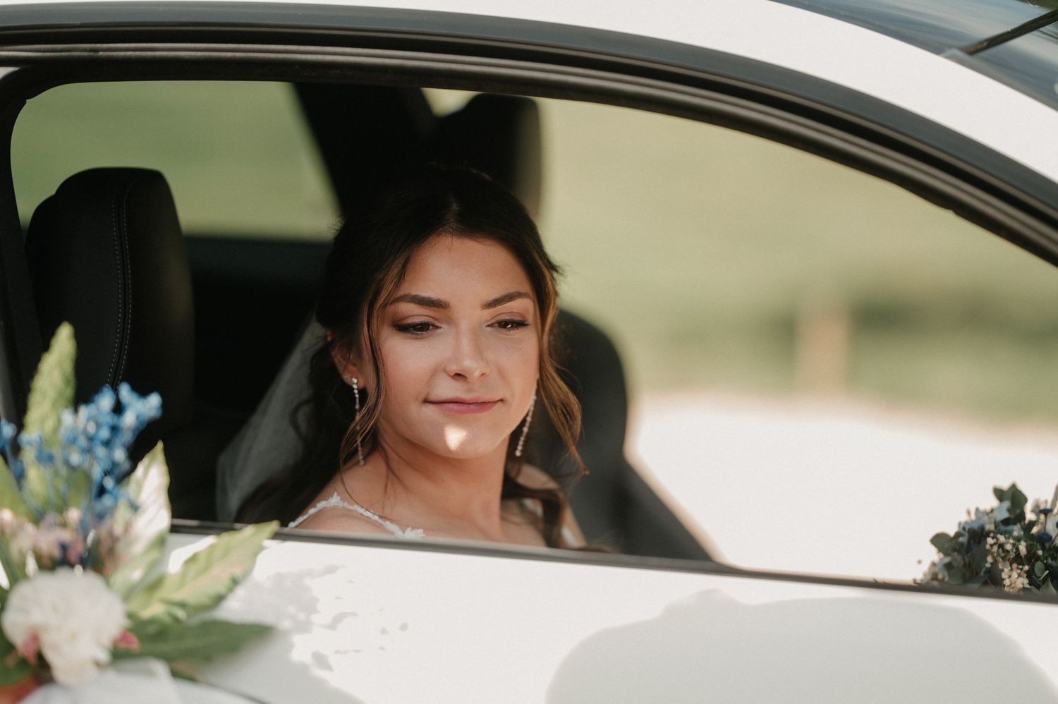 A car interior view showing floral arrangements and decorative elements for a wedding.
