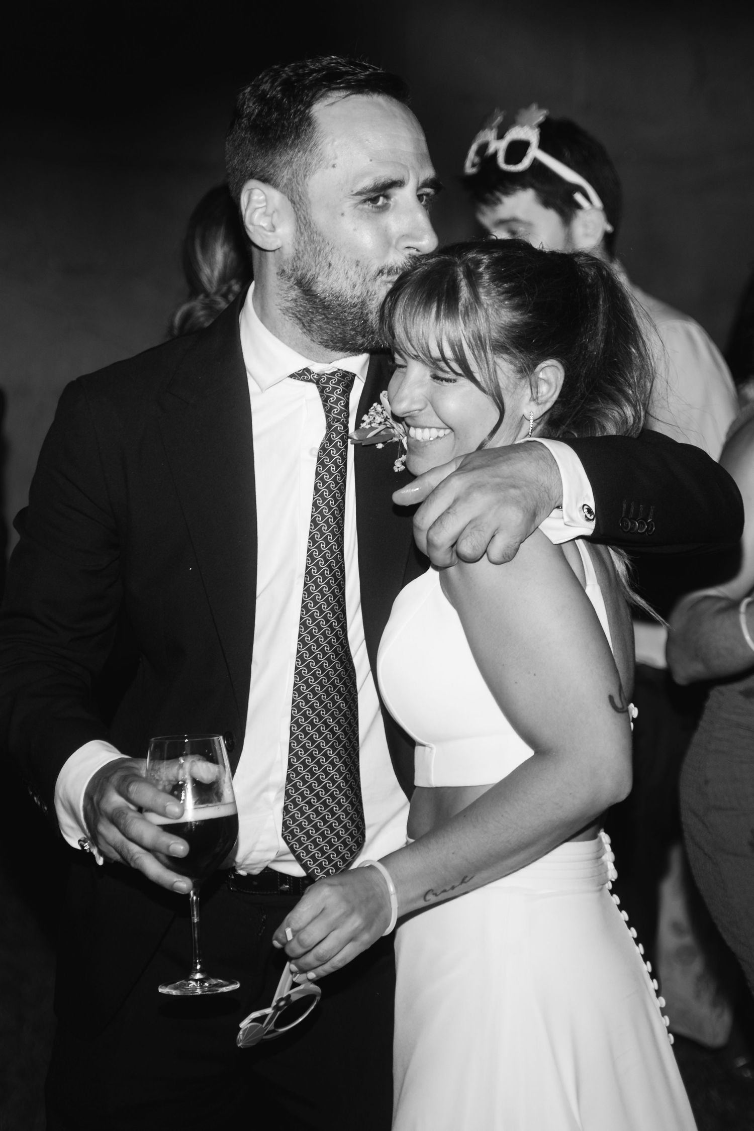 A couple shares an intimate dance moment at their wedding reception in black and white.