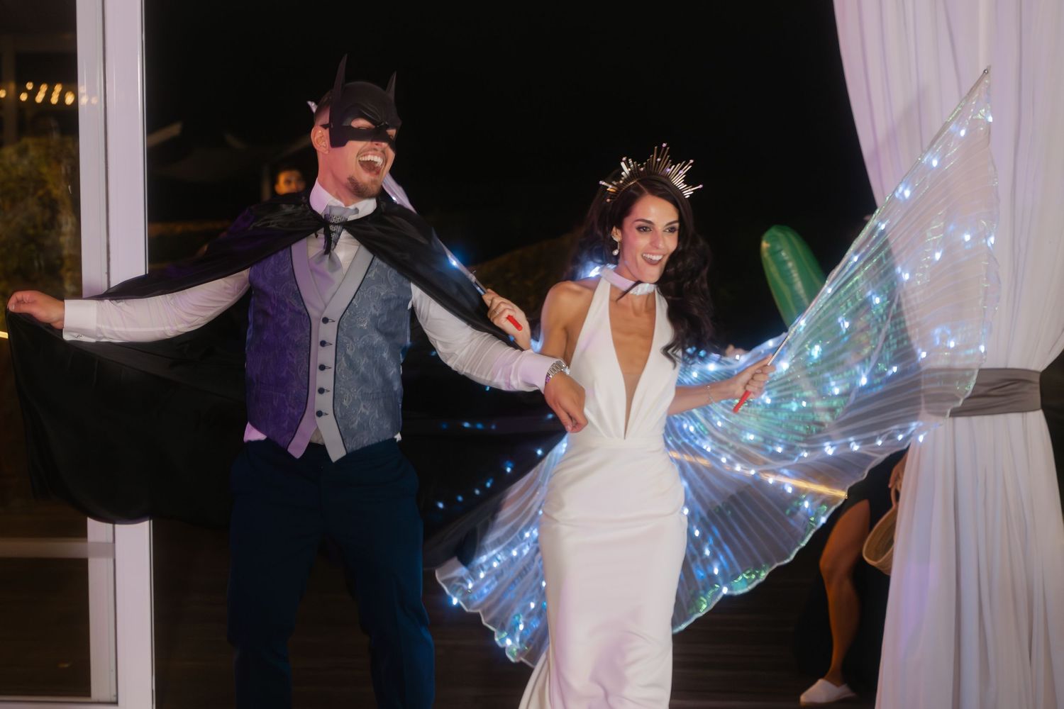 A couple performs their first dance at a wedding reception with twinkle lights creating a magical atmosphere.