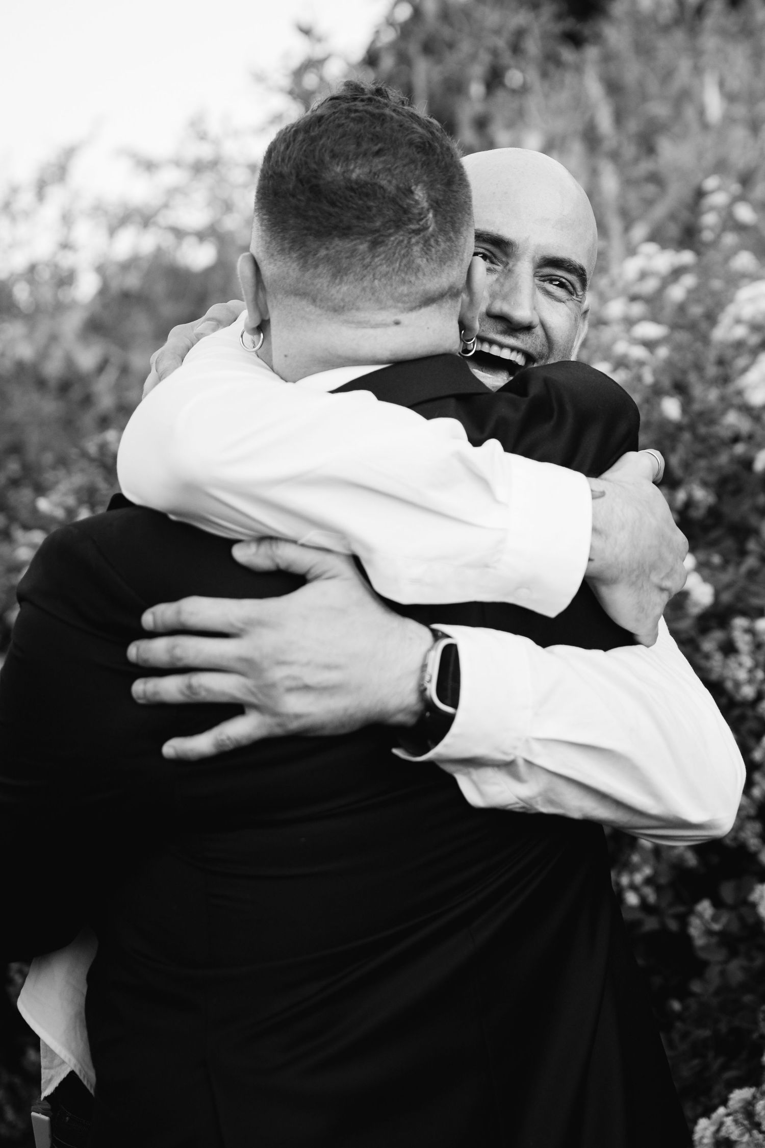 Two people sharing an emotional embrace in black and white photography.