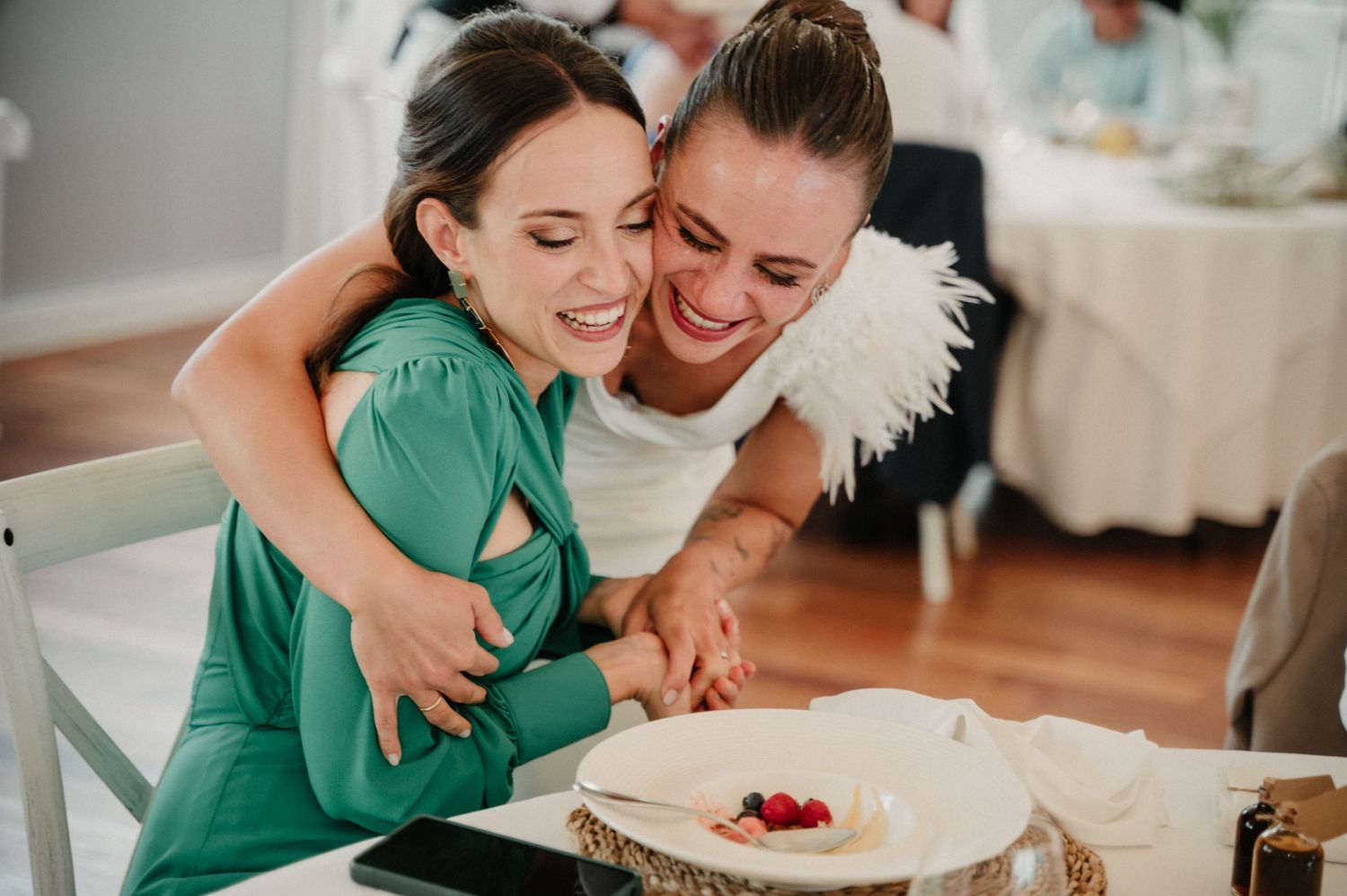 Couple sharing an intimate moment while enjoying dessert together in a bright kitchen setting.