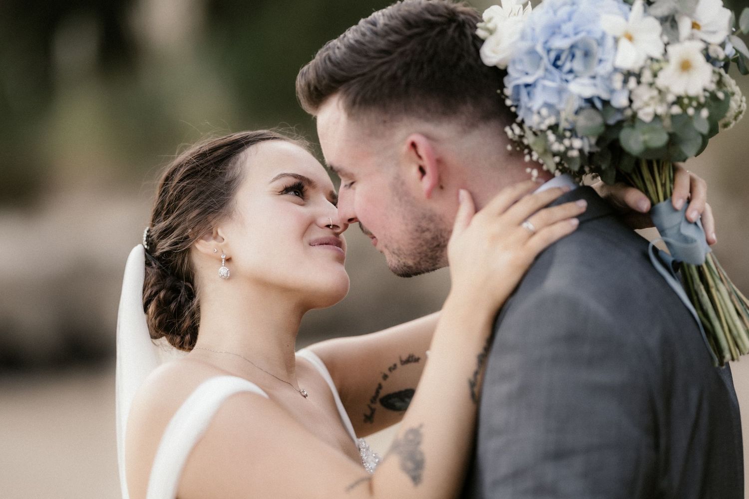 A romantic sequence of wedding couple moments showing tender embraces and kisses in an outdoor setting.