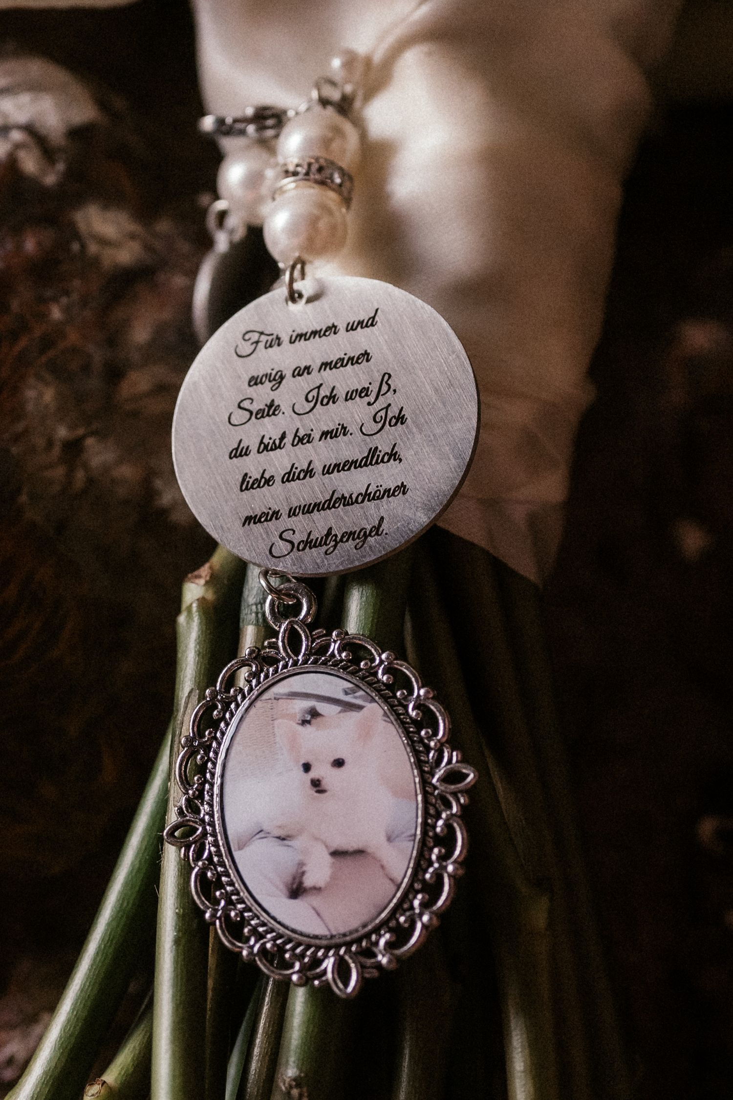 A series of vintage-style pendant necklaces with ornate silver frames and custom text charms displayed on green stems.