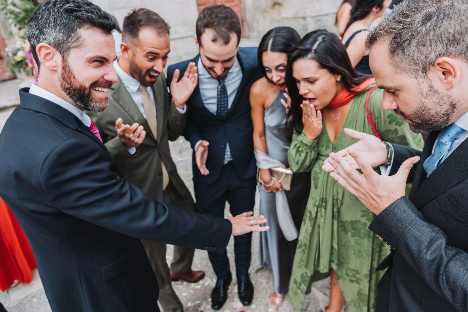 Wedding guests gather and celebrate during a joyful outdoor reception.