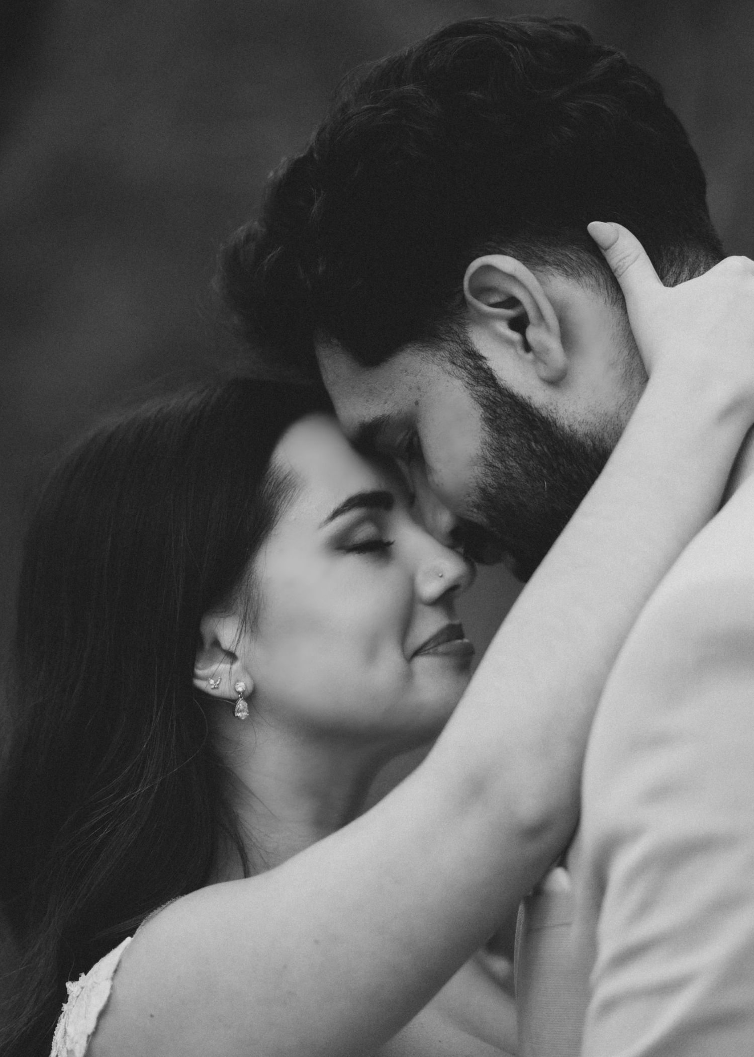 A romantic black and white sequence of a tender embrace and kiss between newlyweds.