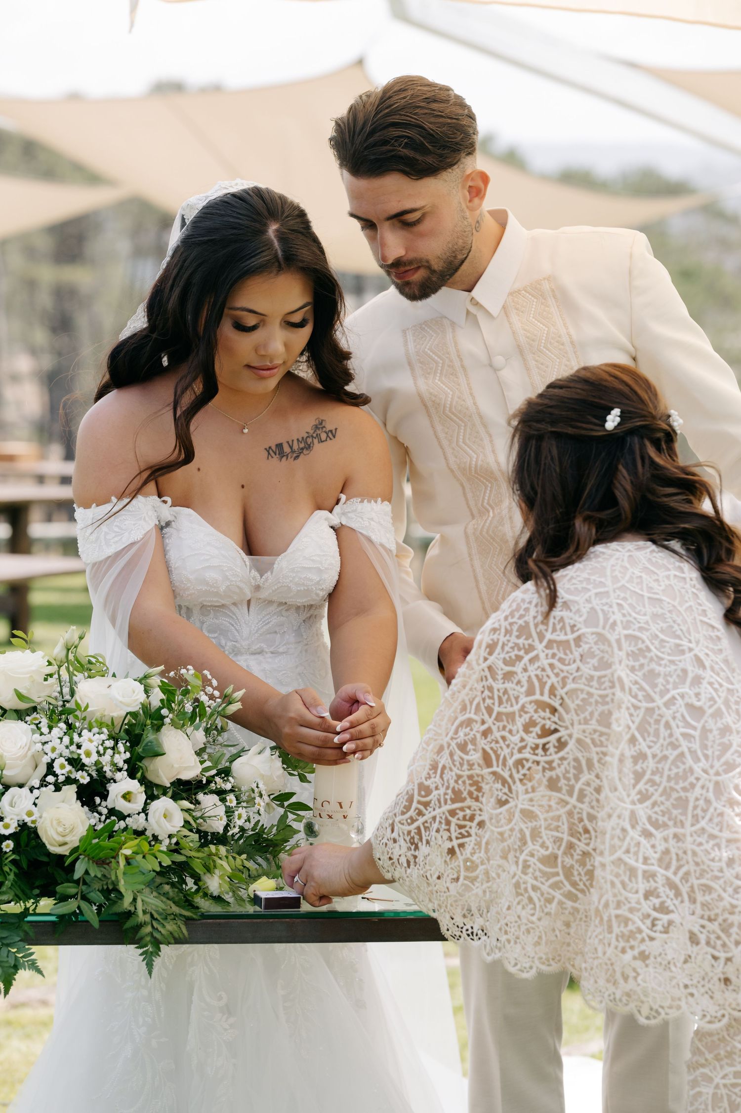 A romantic wedding couple shares intimate moments while looking at their baby in a series of tender photographs.