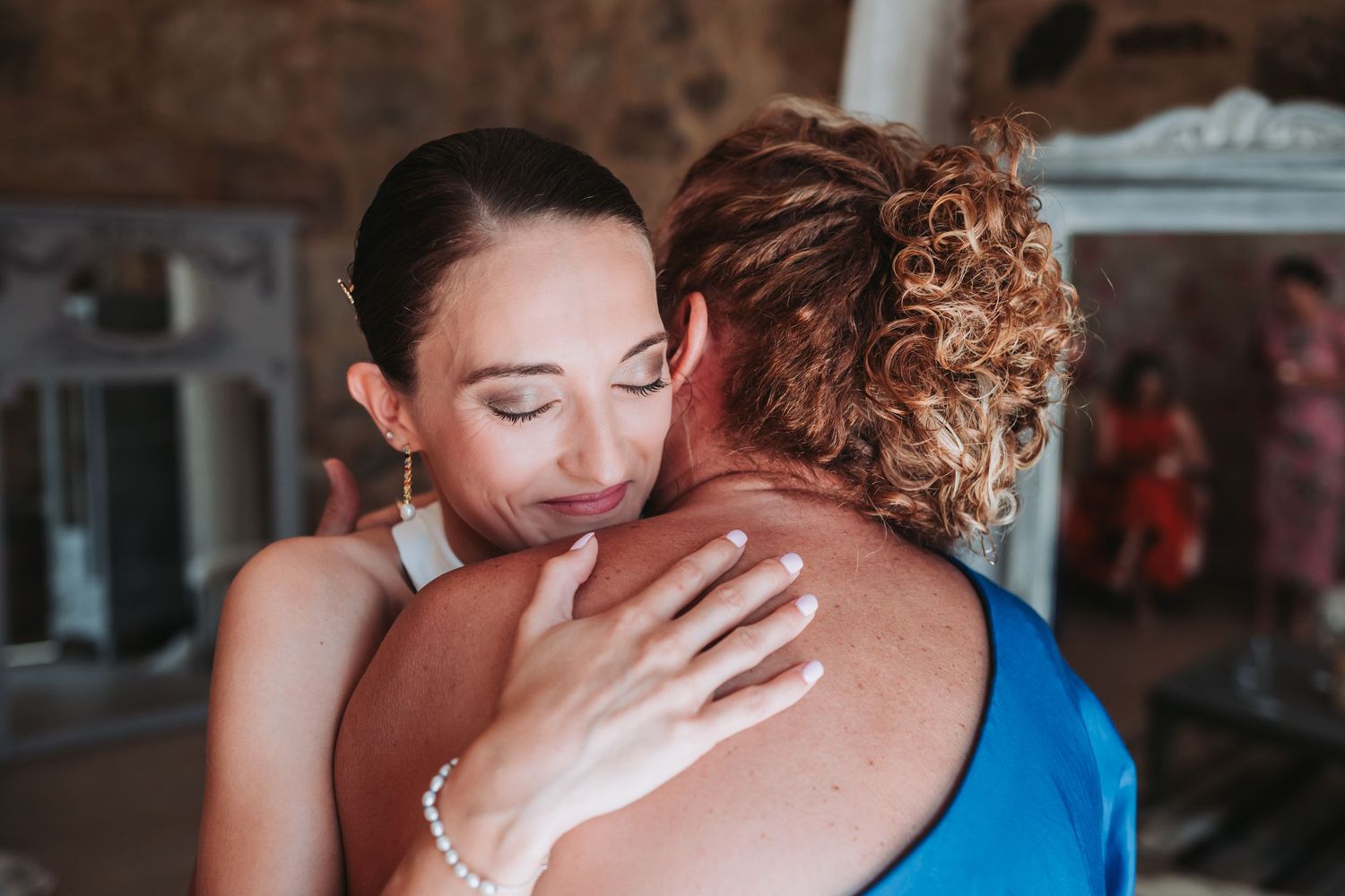 A series of emotional moments captured at a wedding showing embraces and tender interactions between guests.