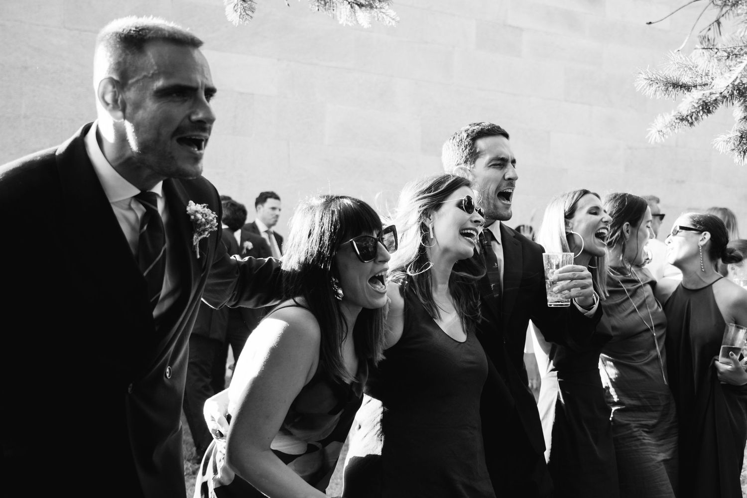A series of black and white photographs showing people laughing and enjoying themselves at a social gathering.