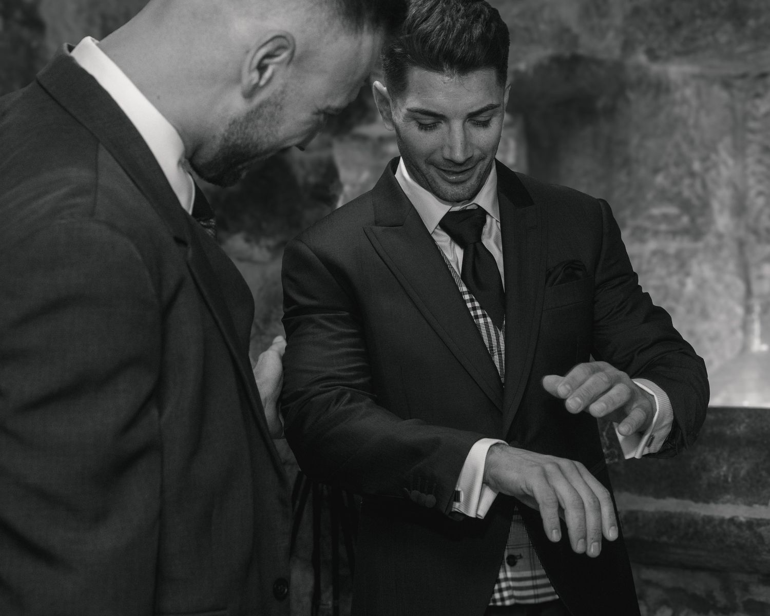 Black and white photo series showing people in suits engaged in animated conversation and laughter.