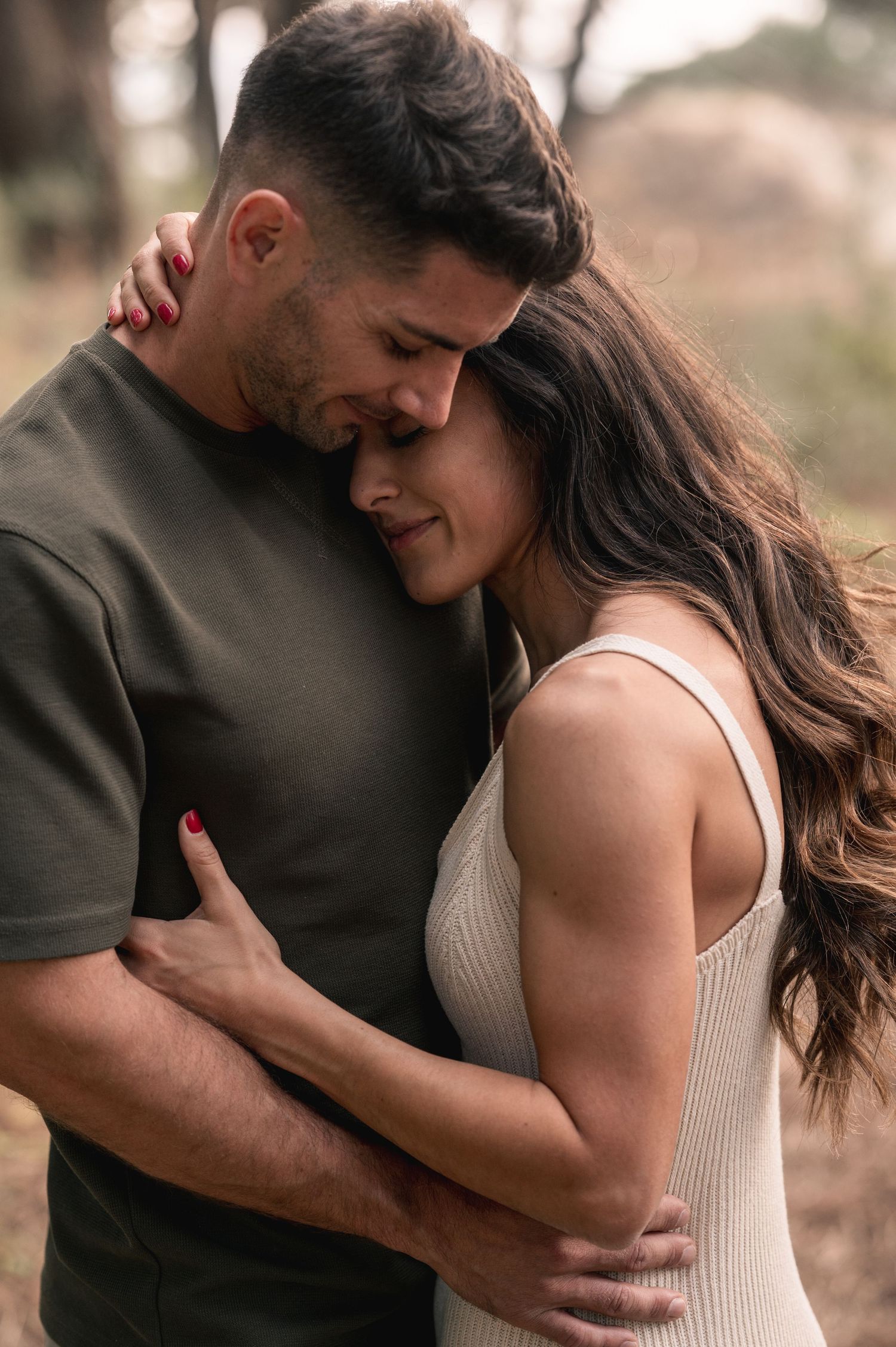 Romantic couple embraces intimately in a series of tender moments captured in warm outdoor lighting.