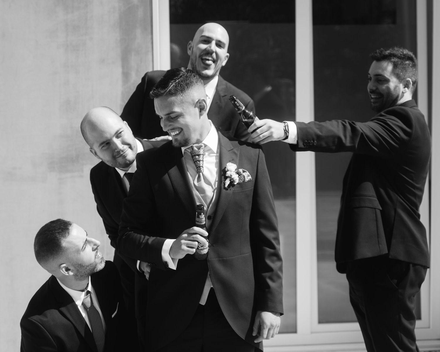 A candid black and white photo sequence showing joyful moments at a wedding celebration.